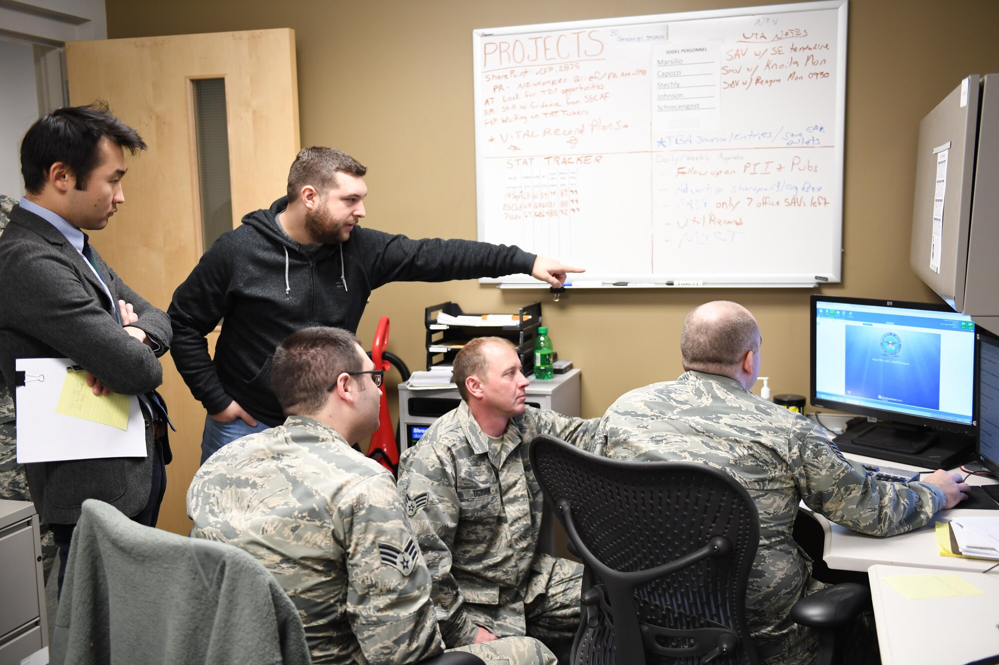 Luke Osterritter, cyber security engineer with Carnegie Mellon University, and Jerry Guo, PhD student with the Tepper School of Business, assist Airmen during exercise Cyber Tepper, a cyber exercise hosted by Carnegie Mellon University, at the Pittsburgh International Airport Air Reserve Station, Pennsylvania, Nov. 4, 2016. The exercise was part of Guo’s study to determine if teams that rely less on procedures will perform better in dynamic environments. (U.S. Air Force photo by Senior Airman Beth Kobily)