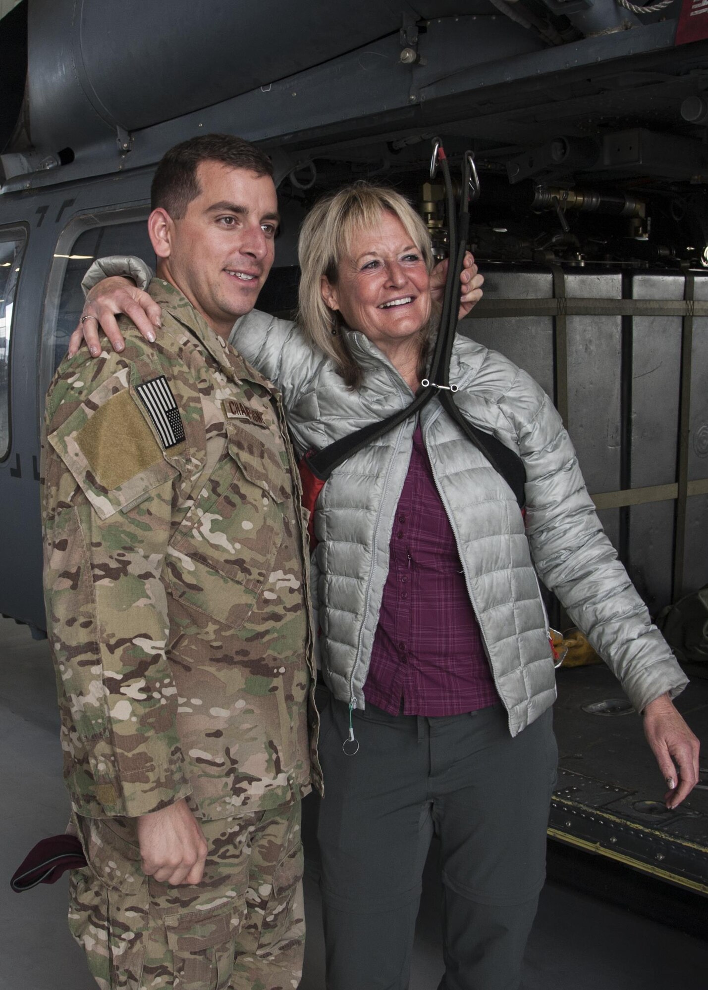 Ronda Ramsier poses with Tech Sgt. Matthew Champagne, U.S. Air Force Pararescue School instructor, in the harness used to rescue her after she became stranded during an August hike near Durango, Colorado. More than 50 Airmen assisted in the 12 hour search-and-rescue mission. 