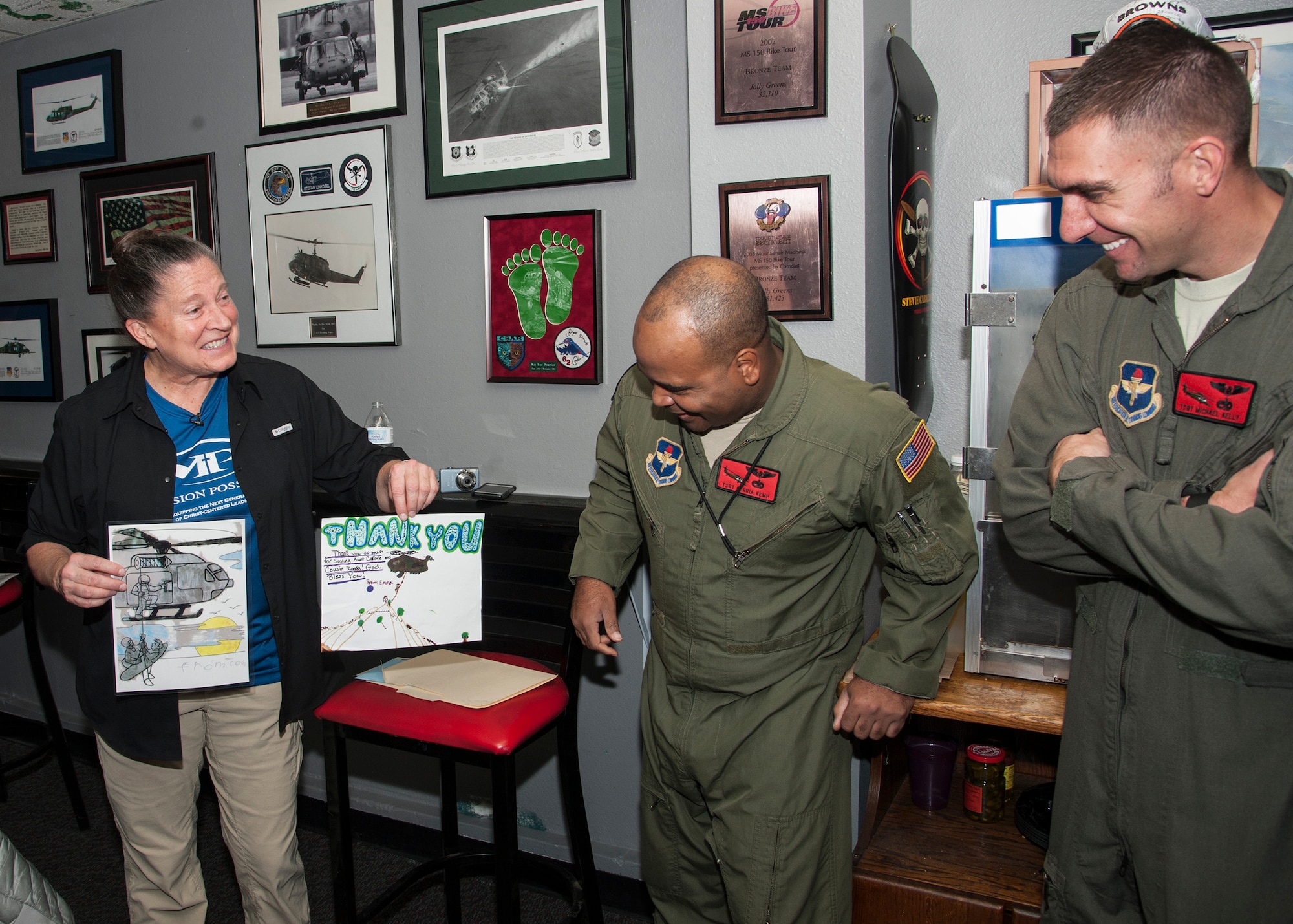 Carol Powell presents Airmen from the 58th Special Operations Wing and 512th Rescue Squadron with pictures created by neighborhood children thanking them for her rescue. Powel become stranded during an August hike near Durango, Colorado. More than 50 Airmen assisted in the 12 hour search-and-rescue mission. 