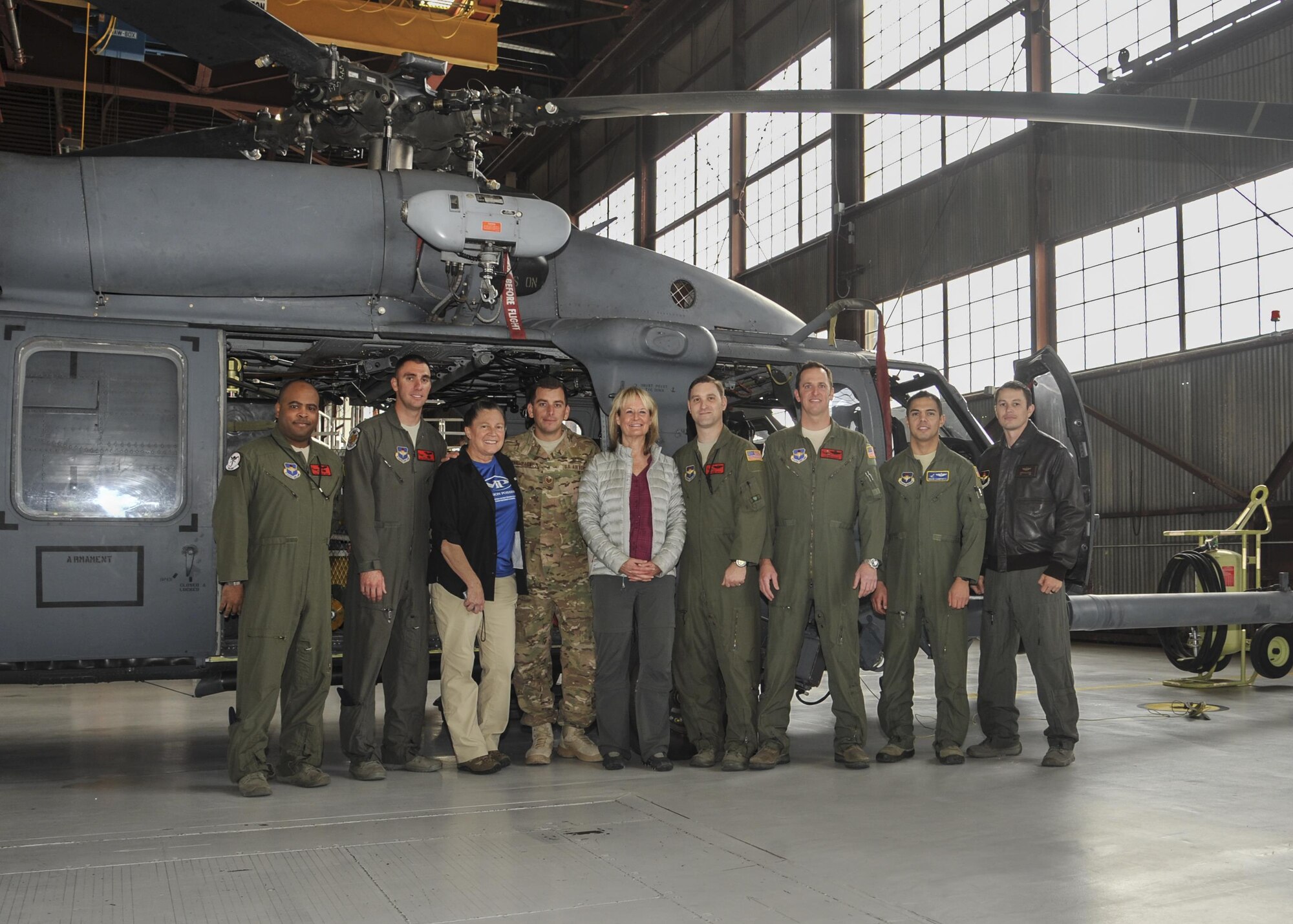 Carol Powell and Ronda Ramsier take a photo with 58th Special Operation Wing and 512th Rescue Squadron members in front of one of the HH-60G Pavehawks used to perform a search-and-rescue for them. Powell and Ramsier  became stranded for 36 hours with their two llamas during an evening hike early August. The hikers returned to Kirtland Dec. 12 to thank the members of the units who rescued them.