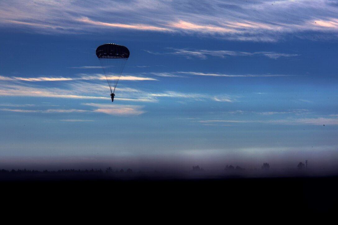A U.S. Army airborne specialist parachutes in the sky after a sustained jump during the 19th Annual Randy Oler Memorial Operation Toy Drop, Dec. 14, 2016, at Luzon Drop Zone, Camp Mackall, N.C. The OTP tradition was established in 1998 by the late U.S. Army Reserve Staff Sgt. Randy Oler, Civil Affairs and Psychological Operations Command soldier with 1,200 soldiers participating and has grown into a multinational exercise with 4,000 paratroopers. (U.S. Air Force photo by Airman 1st Class Greg Nash)   