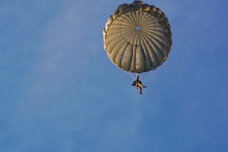 A U.S. Army airborne specialist prepares to land during the 19th Annual Randy Oler Memorial Operation Toy Drop, Dec. 15, 2016, at Luzon Drop Zone, Camp Mackall, N.C. Although the intent of OTD was to give underprivileged kids toys for Christmas, Fort Bragg’s Civil Affairs & Psychological Operations Command (Airborne) utilizes the second phase of the event to enhance airborne training. (U.S. Air Force photo by Airman 1st Class Greg Nash)   