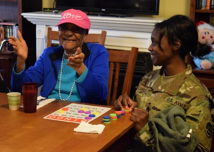 Georgia Army National Guard Sgt. 1st Class Maurika Flores brings joy to a resident of Azalea Manor Assisted Living Facility in Marietta. The Guardsmen visited with residents, presented gifts, played Bingo and chatted with residents.