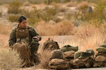 A Marine with the 15th Marine Expeditionary Unit rests during a non-combatant evacuation operation scenario Dec. 12, 2016, at Desert Rock Airport, Nev. Creech Airmen trained alongside Marine and Navy personnel and assisted in pre-deployment training. (U.S. Air Force photo by Airman 1st Class James Thompson)