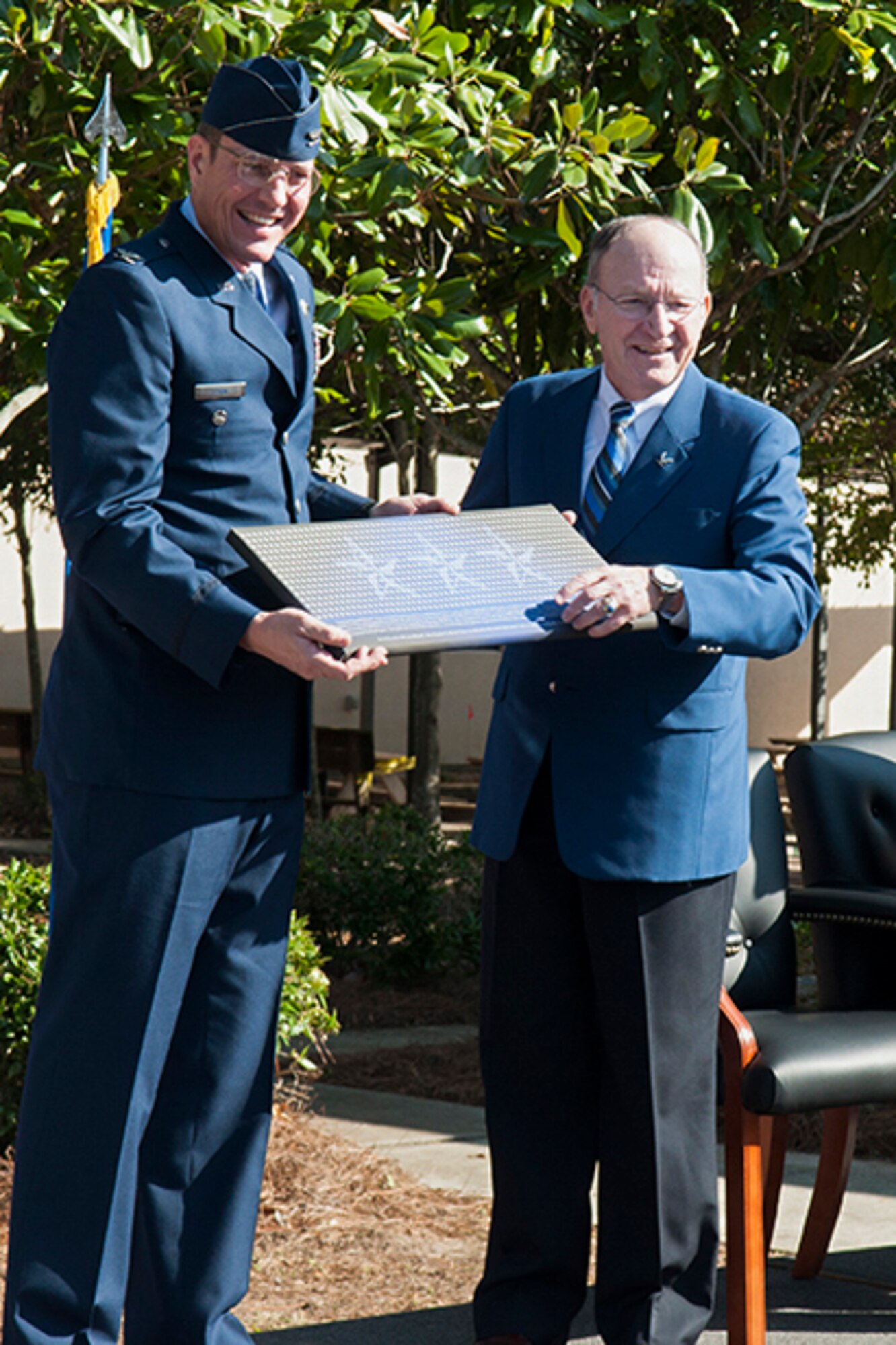 Col. Joel Cook, left, vice commander of the 505th Command and Control Wing, presents retired Lt. Gen. Michael Short with a plaque during a building dedication ceremony at Hurlburt Field, Fla., Dec. 16, 2016. Short, an Air Force Academy graduate who retired from the Air Force in 2000, dedicated more than 50 years of service to the Air Force. (Courtesy photo)