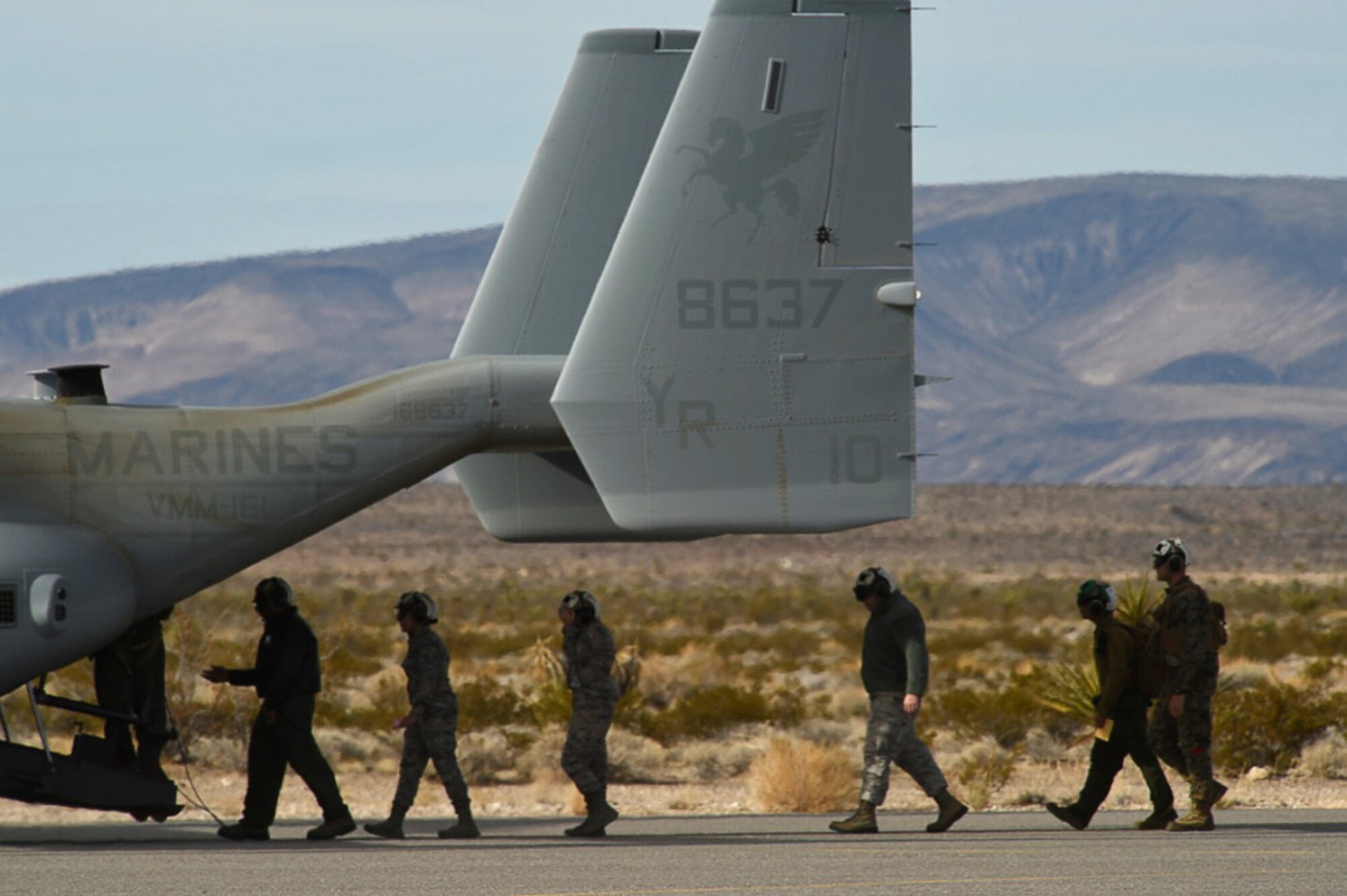 Airmen assigned to the 432nd Wing/432nd Air Expeditionary Wing enter an MV-22 Osprey Dec. 12, 2016, at Desert Rock Airport, Nev. Creech Airmen were exercise participants during a non-combatant evacuation operation scenario evacuated via two MV-22 Ospreys. (U.S. Air Force photo by Airman 1st Class James Thompson)