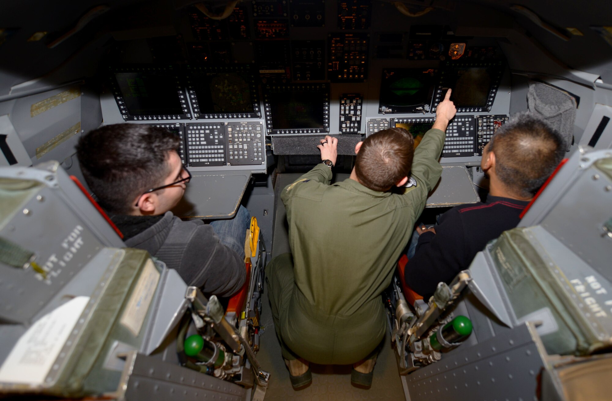 Tech. Sgt. Roderick Marquez, a logistics non-commissioned officer in charge assigned to the 28th Civil Engineer Squadron, and Shawn Horton, a client systems technician assigned to the 28th Munitions Squadron, join Capt. Anthony Bunker, a weapon systems officer assigned to the 34th Bomb Squadron, in a B-1 simulator in Ellsworth Air Force Base, S.D., Dec. 20, 2016. The 28th Operations Support Squadron hosted B-1 simulator tours for a few days allowing military members and their families a chance to “fly” the BONE. (U.S. Air Force photo by Airman 1st Class Donald C. Knechtel)