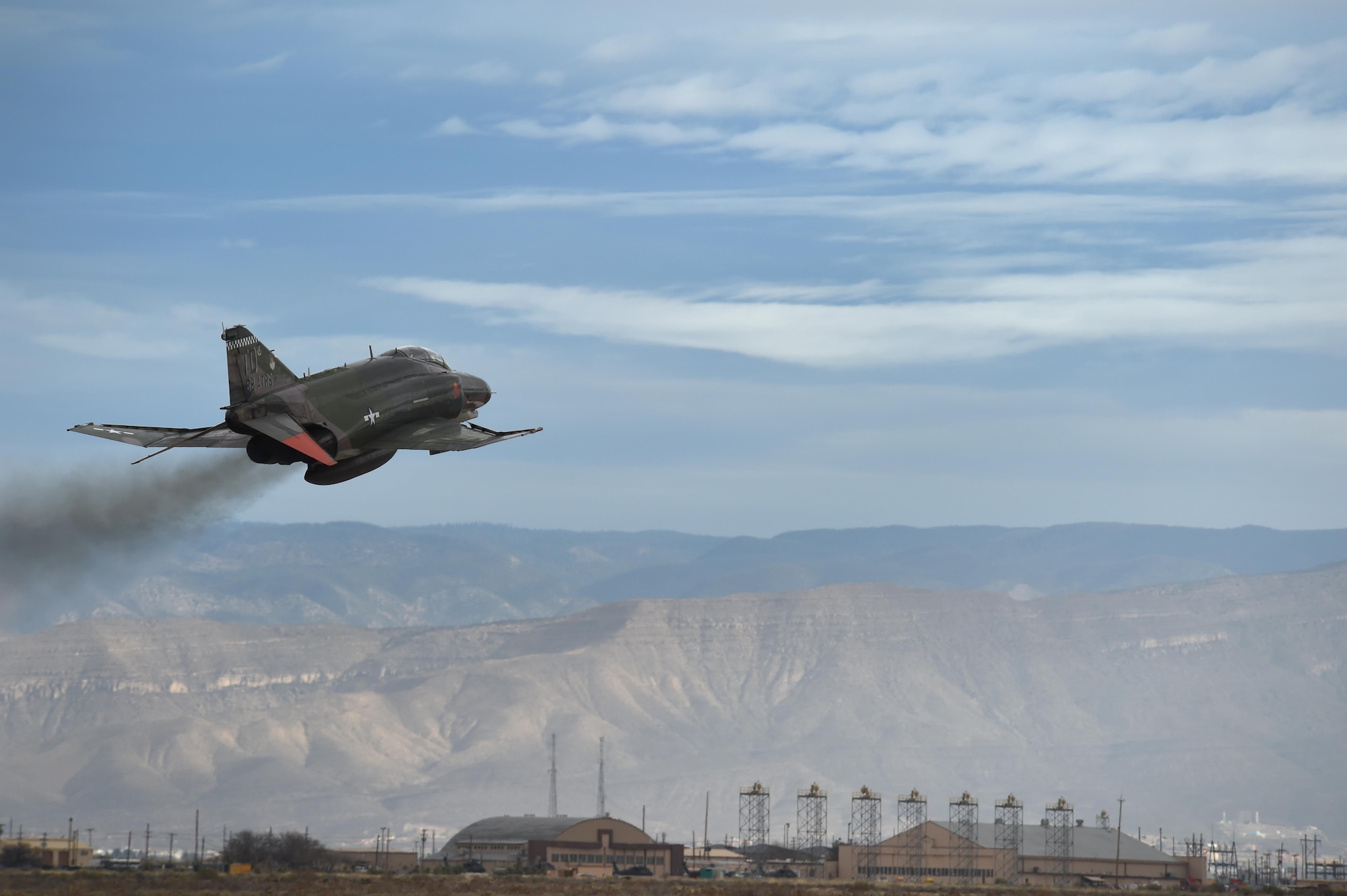 A QF-4 Phantom flies over Holloman Air Force, Base, N.M., during the Phinal Phlight event on Dec. 21, 2016. This event marks the end of the aircraft’s 53 years of service to the Air Force. (U.S. Air Force photo by Staff Sgt. Eboni Prince)