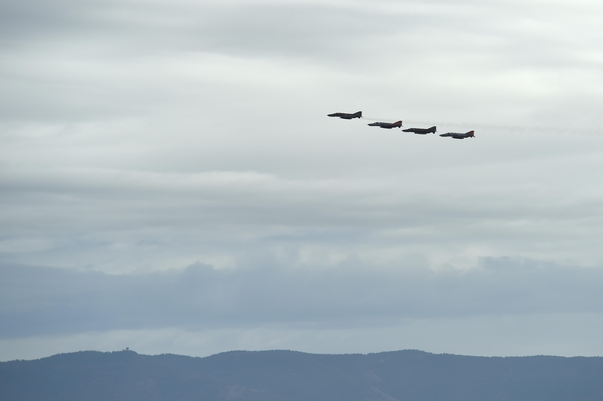 A QF-4 Phantom Four Ship formation flies over Holloman Air Force, Base, N.M., during the Phinal Phlight event on Dec. 21, 2016. This event marks the end of the aircraft’s 53 years of service to the Air Force. (U.S. Air Force photo by Staff Sgt. Eboni Prince)