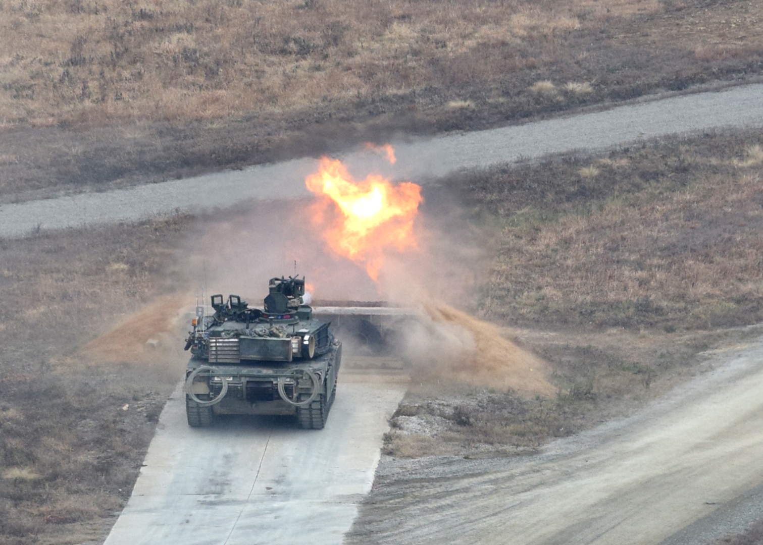 POCHEON, Republic of Korea -- An M1A2 Abrams tank from 2nd Battalion, 34th Armor Regiment, 1st Armored Brigade Combat Team, 1st Infantry Division, fires its main weapons system during a live-fire training exercise at the Rodriguez Live Fire Complex Nov. 30. The battalion conducted the large-scale, life-fire exercise as part of a 30-day rotation to the RLFC in order to remain qualified on their main weapons systems and be ready to "Fight Tonight" in support of the 2nd Inf. Div. / ROK-U.S. Combined Division. (U.S. Army Photo by Capt. Jonathan Camire, 1st ABCT Public Affairs/Released)