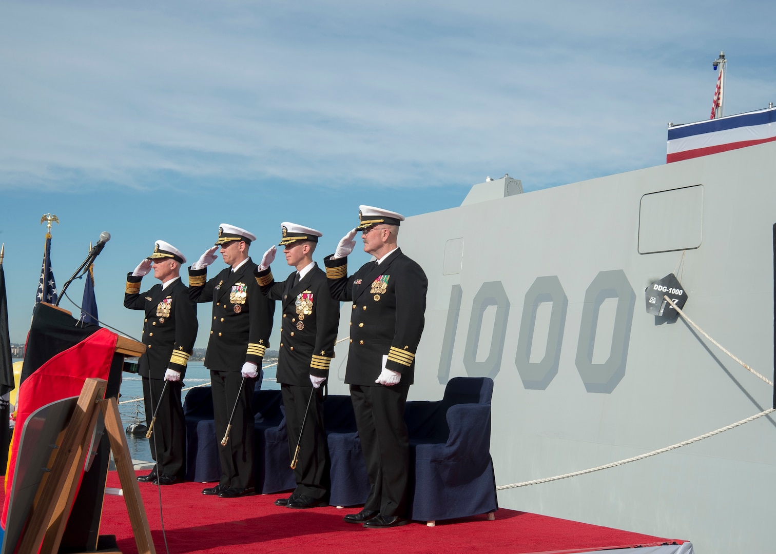 SAN DIEGO (Dec. 20, 2016) Left to right, Vice Adm. Thomas Rowden, commander, Naval Surface Forces, Capt. James A. Kirk, outgoing commanding officer (CO) of  guided-missile destroyer USS Zumwalt (DDG 1000), Capt. Scott A. Tait, in-coming CO of Zumwalt, and Capt. W. Kyle Fauntleroy, Force Chaplain, Surface Force, U.S. Pacific Fleet, salute the ensign during a change of command ceremony at Naval Base San Diego. (U.S. Navy photo by Petty Officer 2nd Class Zachary Bell/Released)