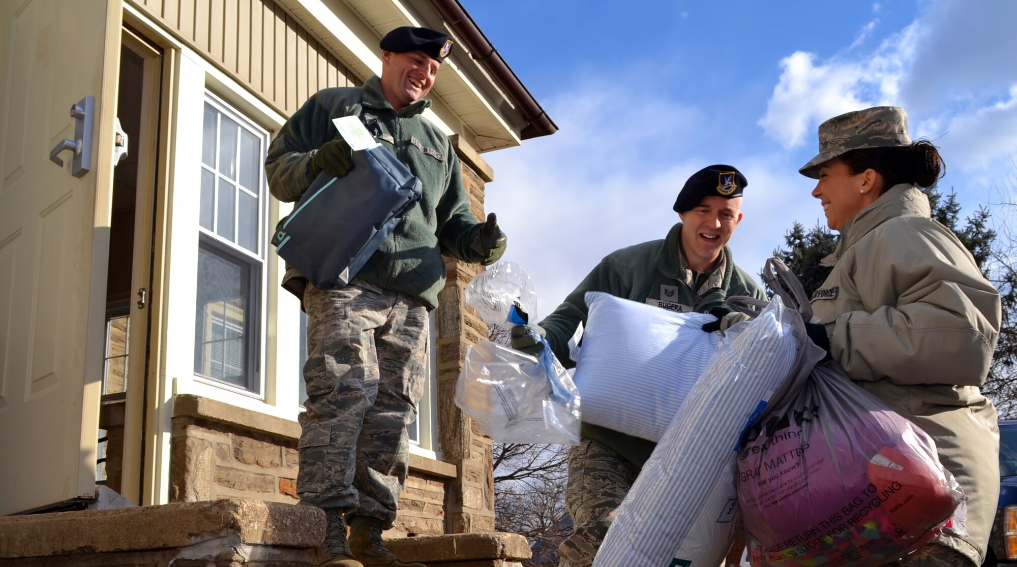 On right, Senior Master Sgt. Lauren Paul, 111th Force Support Squadron service superintendent, holds armfuls of donated items to pass off to 111th Security Forces Squadron members during the delivery to a local child services facility in Warminster, Pennsylvania, Dec. 15, 2016. Members of the Wing have conducted The Angel Tree holiday donation drive for more than 20 years. (U.S. Air National Guard photo by Tech. Sgt. Andria Allmond)
