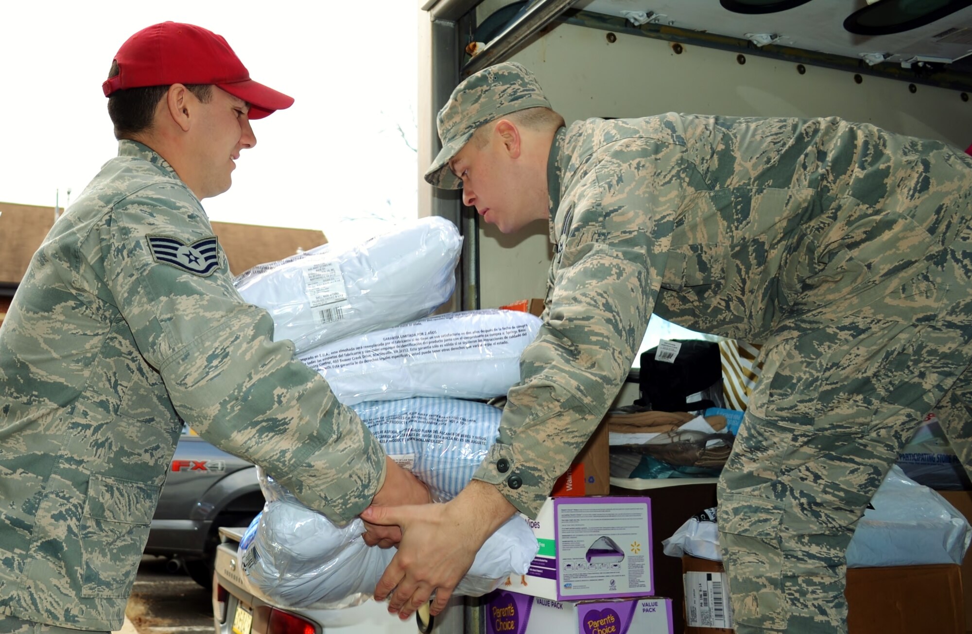 On right, Senior Airman Igor Karlov, 111th Logistics Readiness Squadron supply technician, receives donated items from a member of the 201st Rapid Engineer Deployable Heavy Operational Repair Squadron Engineer (RED HORSE) Squadron, Det. 1, Dec. 15, 2016 at Horsham Air Guard Station, Pa. The 111th Attack Wing has donated toys and other items to a local children’s care facility for more than two decades. (U.S. Air National Guard photo by Tech. Sgt. Andria Allmond)
