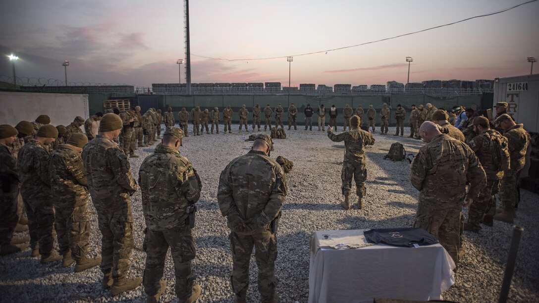 Chaplain (Capt.) Benjamin Quintanilla, 455th Air Expeditionary Wing chaplain, says a prayer to a gathered group of Air Force Office of Special Investigations Expeditionary Detachment 2405 and 455th Expeditionary Security Forces Squadron members before a “Ruck March to Remember” fallen comrades Dec. 21, 2016 at Bagram Airfield, Afghanistan. It is a tradition for Task Force Crimson members to gather in a prayer circle before going out on a mission outside the wire. (U.S. Air Force photo by Staff Sgt. Katherine Spessa)