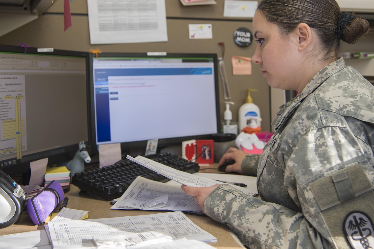 U.S. Army Staff Sgt. Valerie Garvin, Public Health Command District animal care specialist, budgets the Veterinary Treatment Facility income at Joint Base Andrews, Md., Dec. 20, 2016. As an animal care specialist, she manages and files everything in the facility including budgets, medications and patients. (U.S. Air Force photo by Airman 1st Class Valentina Lopez)