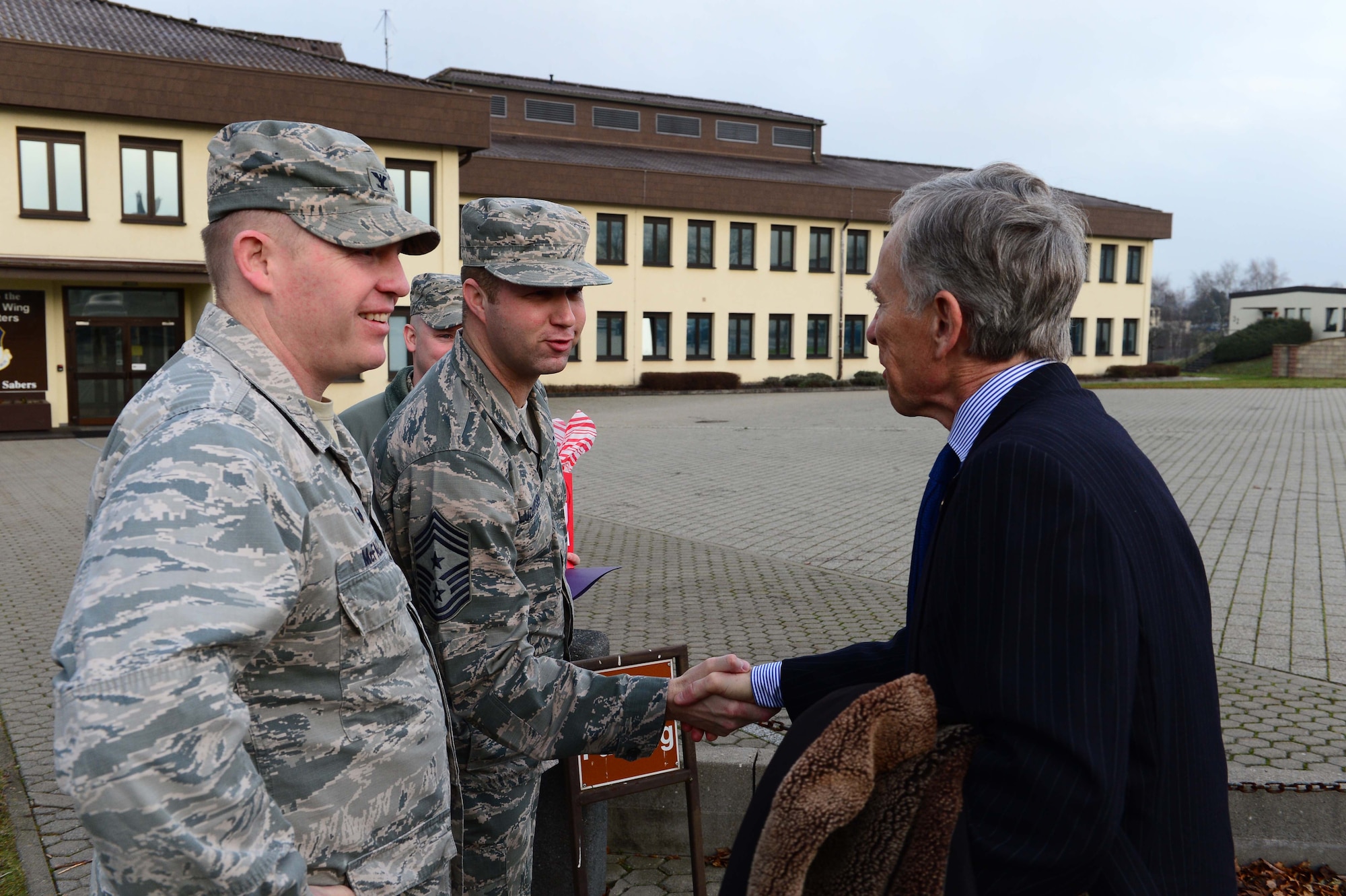 David McKean, right, U.S. Ambassador to Luxembourg, is greeted by Col. Joe McFall, left, 52nd Fighter Wing commander, and Chief Master Sgt. Edwin Ludwigsen, middle, 52nd FW command chief, outisde the wing headquarters building after arriving at Spangdahlem Air Base, Germany, Dec. 20, 2016. This was McKean's first visit to the base as he was briefed by leadership about the Saber Nation mission and different capabilities of the base during his tour. McKean was sworn in as Ambassaor in March 2016. (U.S. Air Force photo by Senior Airman Joshua R. M. Dewberry)