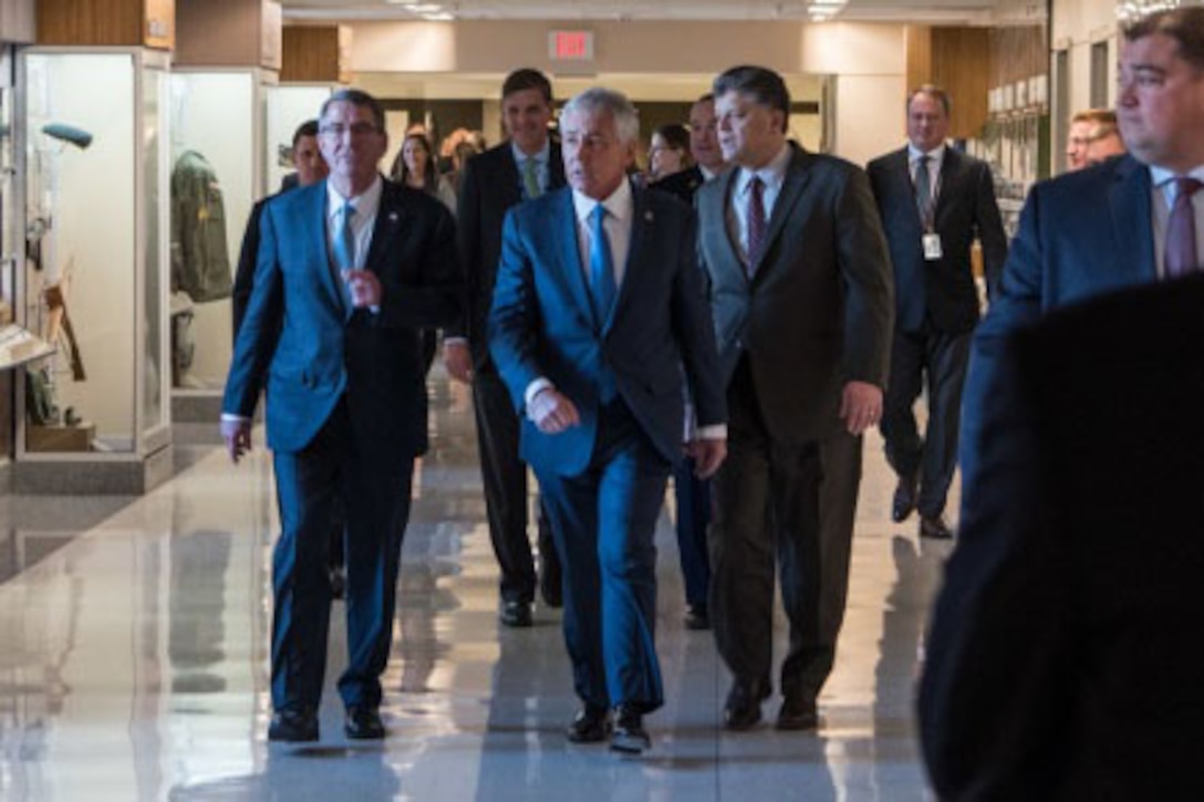 Former Defense Secretary Chuck Hagel, flanked by Defense Secretary Ash Carter and Michael Rhodes, deputy of administration, Office of the Deputy Chief Management Officer, arrive for the opening of a Pentagon exhibit commemorating the 50th anniversary of the Vietnam War, Dec. 20, 2016. DoD photo by Air Force Staff Sgt. Jette Carr