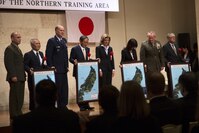 Representatives from the Government of Japan and the United States pose for photos at the conclusion of the Northern Training Area Land Return Ceremony Dec. 22 in Nago City, Okinawa, Japan. The ceremony signified the return of more than 9,852 acres of land from U.S. Forces Japan. The land, which was previously utilized by U.S. Forces Japan as part of the Northern Training Area, is the largest land return to date since 1972. During the ceremony, government representatives from the Japan and the United States gave remarks regarding the return of the land and the importance of the Japan-U.S. alliance.