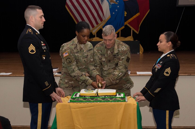 U.S. Army Sgt. Shannon Scott, center left, 221st Military Police Detachment police officer, and U.S. Army Sgt. Maj. Kirk Carlton, center right, Army Training and Support Center senior enlisted advisor, cut a cake during the NCO Corps birthday celebration at Joint Base Langley-Eustis, Va., Dec. 16, 2016. Inspector General Friedrich Wilhelm von Steuben created training objectives that constituted the first written plan for NCO standards, discipline and duty for Gen. George Washington’s Continental Army in Dec. 1777. (U.S. Air Force photo by Airman 1st Class Derek Seifert)