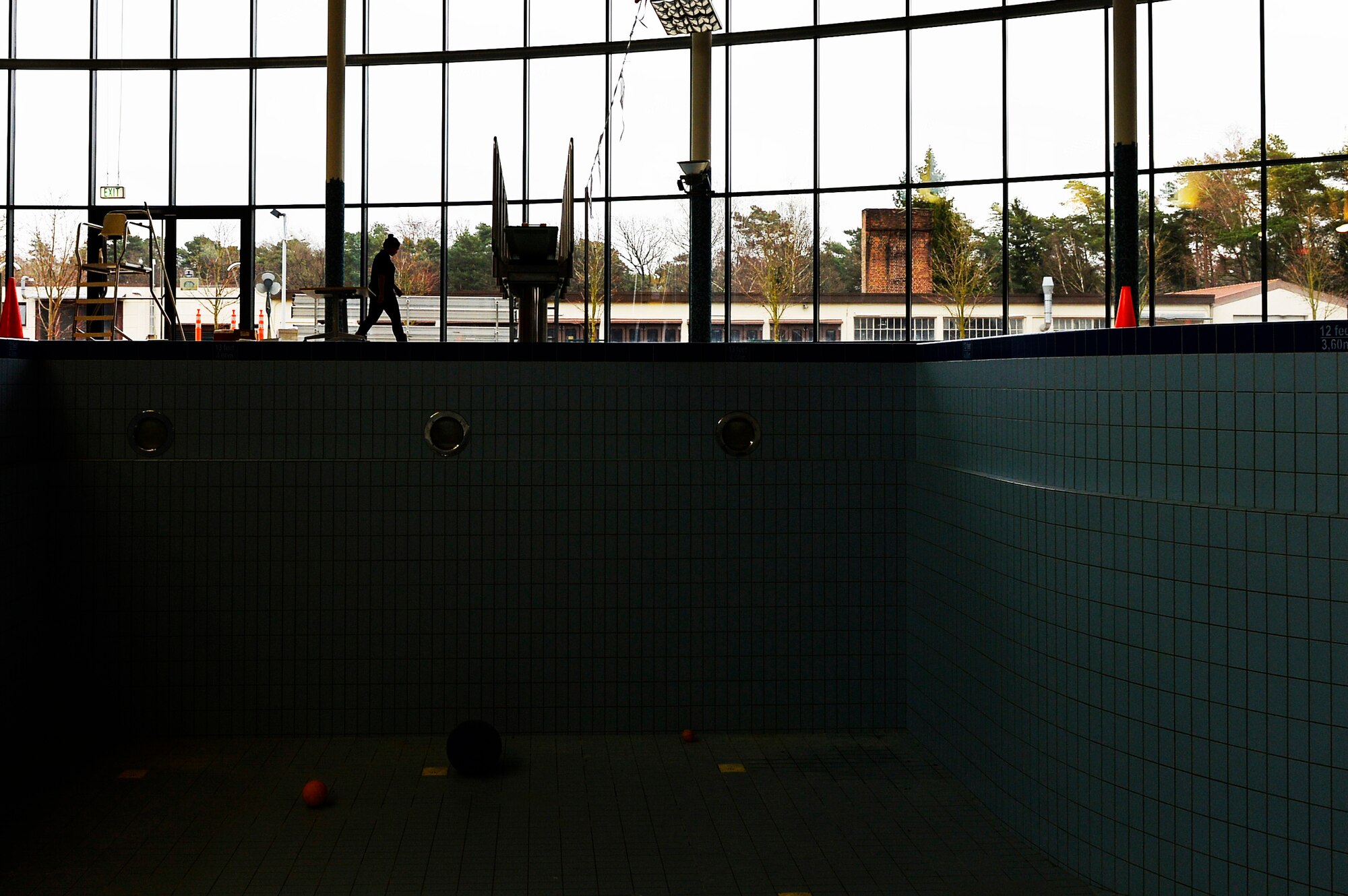 Sarah Alcarez, Ramstein Aquatic Center director, walks by an empty pool at the aquatic center at Ramstein Air Base, Germany, Dec. 15, 2016. The Ramstein Aquatic Center has been closed for annual maintenance work. (U.S. Air Force photo Airman 1st Class Joshua Magbanua)