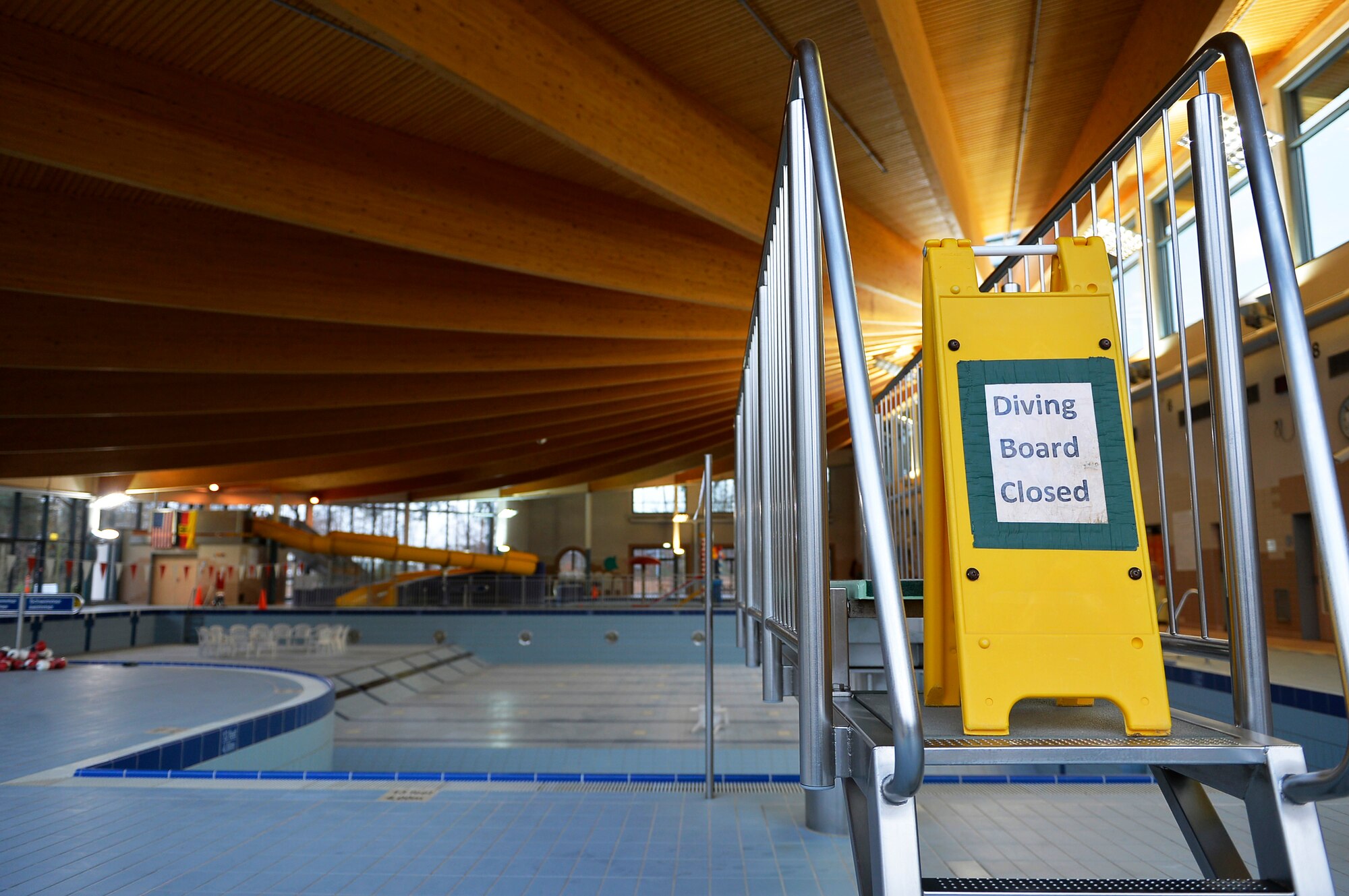 A warning sign blocks off a diving board leading to a drained pool at the aquatic center of Ramstein Air Base, Germany, Dec. 15, 2016. The pools at the Ramstein Aquatic Center have been drained for annual maintenance work. (U.S. Air Force photo Airman 1st Class Joshua Magbanua)