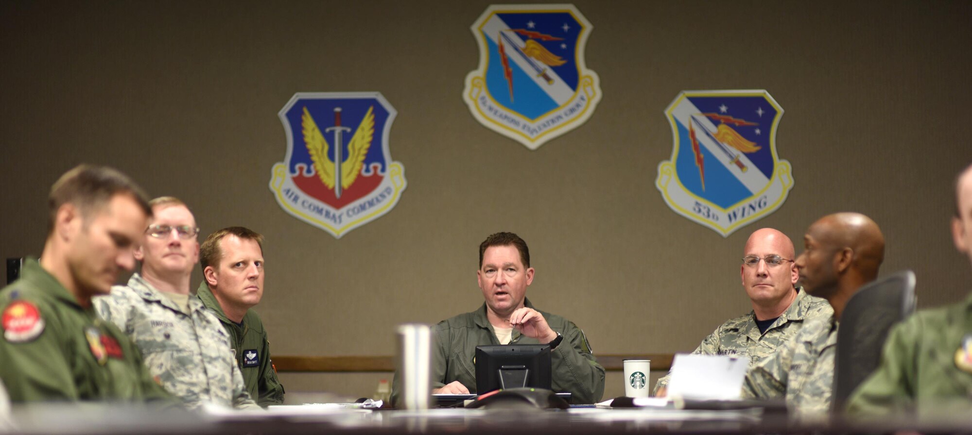 U.S. Air Force Col. Lance Wilkins, 53rd Weapon Evaluations Group commander, listens and responds to Airmen during a PoinT briefing in the 53rd WEG conference room Dec. 16, 2016. The briefing was the first rendition of the units new Power of Innovative Thinking (PoinT) initiative where selected Airmen from different squadrons within the 53rd WEG are presented a problem and have a fiscal quarter to develop plausible solutions. (U.S. Air Force photo by Senior Airman Solomon Cook/Released)