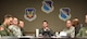 U.S. Air Force Col. Lance Wilkins, 53rd Weapon Evaluations Group commander, listens and responds to Airmen during a PoinT briefing in the 53rd WEG conference room Dec. 16, 2016. The briefing was the first rendition of the units new Power of Innovative Thinking (PoinT) initiative where selected Airmen from different squadrons within the 53rd WEG are presented a problem and have a fiscal quarter to develop plausible solutions. (U.S. Air Force photo by Senior Airman Solomon Cook/Released)