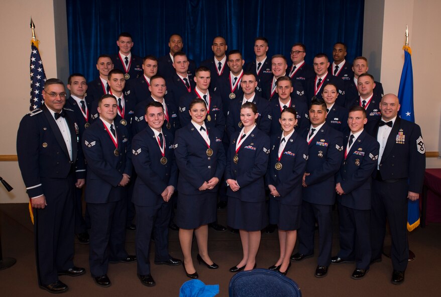 Col. Stephen Kravitsky, 90th Missile Wing commander and Chief Master Sgt. Jeffery Steagall, 90th Missile Wing command chief, pose with the graduating Airman Leadership School Class 17-B students at F.E. Warren Air Force Base, Wyo., Dec. 21, 2016. Enlisted Airmen must complete the rigorous professional military education course to become supervisors of other Airmen. (U.S. Air Force photo by Staff Sgt. Christopher Ruano)