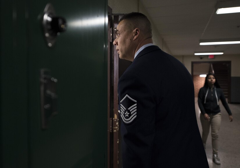 Master Sgt. David Gray, 113th Air National Guard security forces member, walks into a classroom at Charles Carroll Middle School during their Career and Technical Education Fair in New Carrollton, Md., Dec. 21, 2016. This is the fifth time Gray has volunteered to speak with students about the benefits of the U.S. Air Force as a career. (U.S. Air Force photo by Senior Airman Philip Bryant)