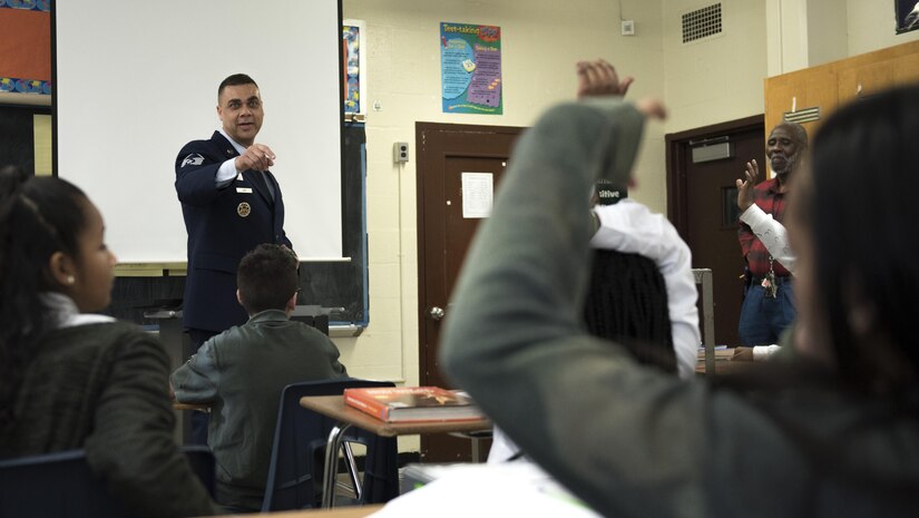 Master Sgt. David Gray, 113th Air National Guard security forces member, picks a student to answer a question at Charles Carroll Middle School during their Career and Technical Education Fair in New Carrollton, Md., Dec. 21, 2016. Gray shared some of his experiences from his 21 years in the U.S. Air Force to classrooms of approximately 20 students in hopes of exposing students to the idea of a career in the Air Force. (U.S. Air Force photo by Senior Airman Philip Bryant)