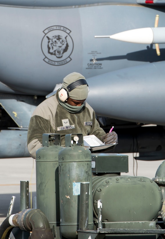 Airman 1st Class Mykel Thomas, 366th Logistics Readiness Squadron's fuels flight, documents gallon amounts from a MH-2 hosecart meter after issuing fuel to an F-15E Strike Eagle during hot pit operations Nov. 16, 2016 at Mountain Home Air Force Base, Idaho. The 366th LRS fuels flight is responsible for safely and efficiently receiving, storing and transferring petroleum, oil and lubricant products in support of the 366th Fighter Wing's mission. (U.S. Air Force photo by 1st Lieutenant Kip Sumner/Released)