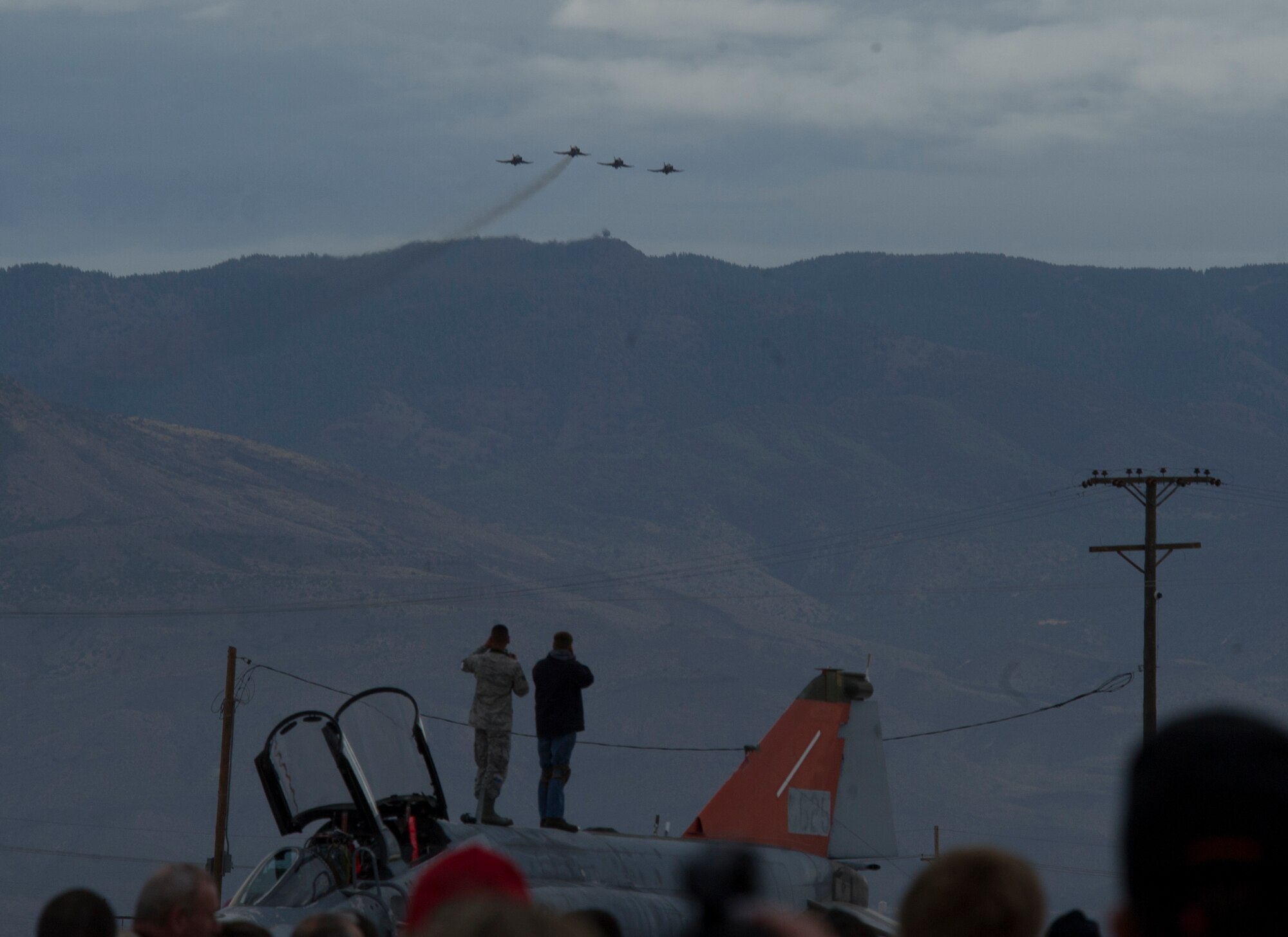 Hundreds of people watch a formation of QF-4 Phantoms during the QF-4 Phinal Phlight event Dec. 21, 2016 at Holloman Air Force Base, N.M. The event included an air demonstration, formal retirement ceremony and a "pet-the-jet" expo with static displays of the QF-4 Phantom, QF-16 Fighting Falcon and E-9 “Widget” to mark the end of the aircraft’s 53 years of service to the Air Force. (U.S. Air Force photo by Master Sgt. Matthew McGovern)