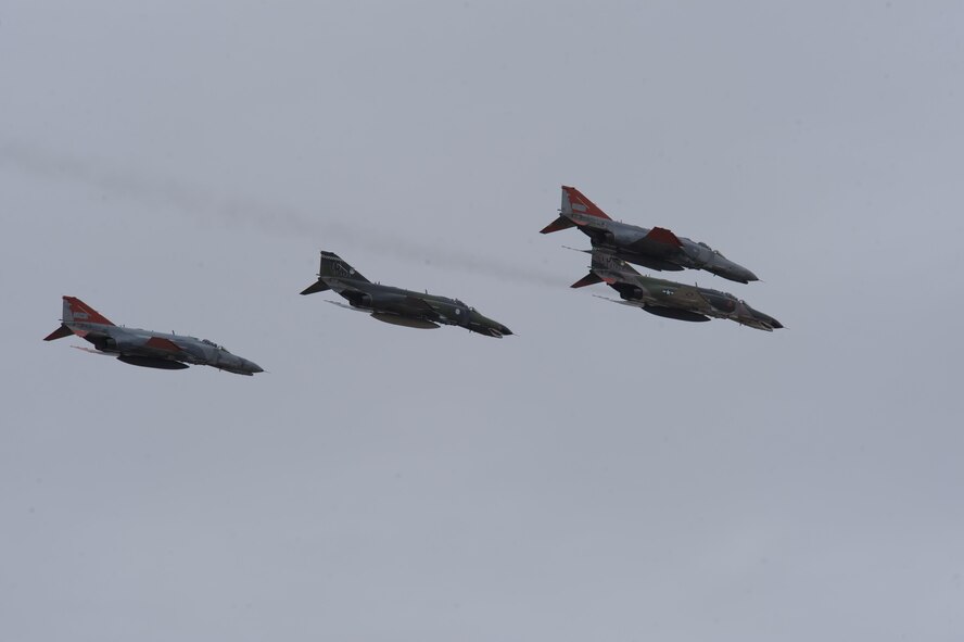 A formation of QF-4 Phantoms fly over hundreds of spectators during the QF-4 Phinal Phlight event Dec. 21, 2016 at Holloman Air Force Base, N.M. The event included an air demonstration, formal retirement ceremony and a "pet-the-jet" expo with static displays of the QF-4 Phantom, QF-16 Fighting Falcon and E-9 “Widget” to mark the end of the aircraft’s 53 years of service to the Air Force. (U.S. Air Force photo by Master Sgt. Matthew McGovern)