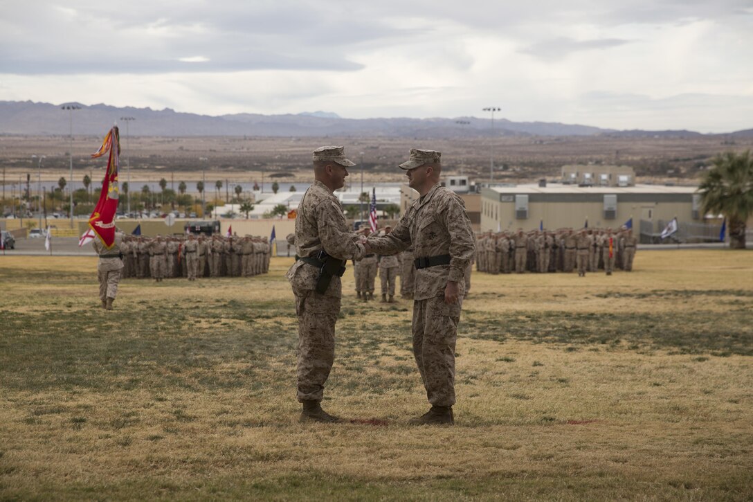Lt. Col. Christopher T. Steele, outgoing commander and Lt. Col. Jonathan Q. Kenney, oncoming commander, 2nd Battalion, 7th Marine Regiment shake hands  during the unit’s change of command ceremony at Lance Cpl. Torrey L. Gray Field aboard Marine Corps Air Ground Combat Center Twentynine Palms, Calif., Dec. 15, 2016. (Official Marine Corps Photo by Cpl. Julio McGraw/Released)
