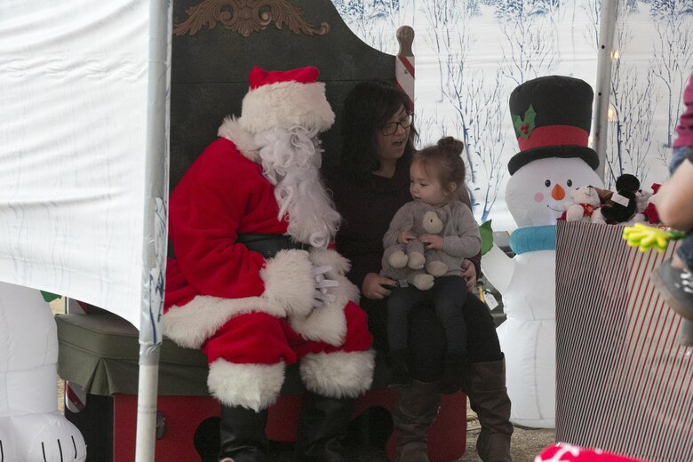 Santa sits with a family from 1st Battalion, 7th Marine Regiment, during the battalion’s family day held at Del Valle Field aboard Marine Corps Air Ground Combat Center Twentynine Palms, Calif., Dec. 15, 2016. (Official Marine Corps photo by Cpl. Thomas Mudd/Released)