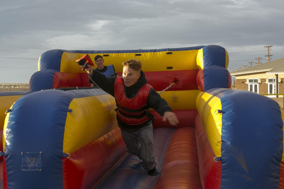 Cpl. Larry Hastings, team leader, 1st Battalion, 7th Marine Regiment, plays on a bungee run game during the battalion’s family day at Del Valle Field aboard Marine Corps Air Ground Combat Center Twentynine Palms, Calif., Dec. 15, 2016. (Official Marine Corps photo by Cpl. Thomas Mudd/Released)