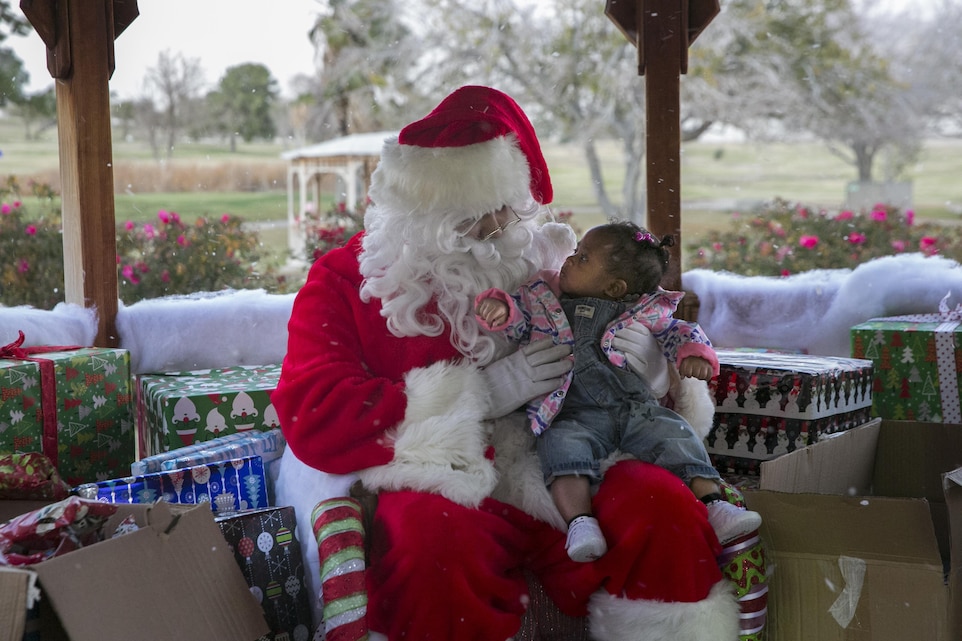 Santa Claus asks a little girl what she wants for Christmas during the Headquarters Battalion Christmas at the North Pole Holiday Party at Desert Winds Golf Course aboard Marine Corps Air Ground Combat Center, Twentynine Palms, Calif., Dec. 16, 2016. (Official Marine Corps photo by Lance Cpl. Dave Flores/Released)