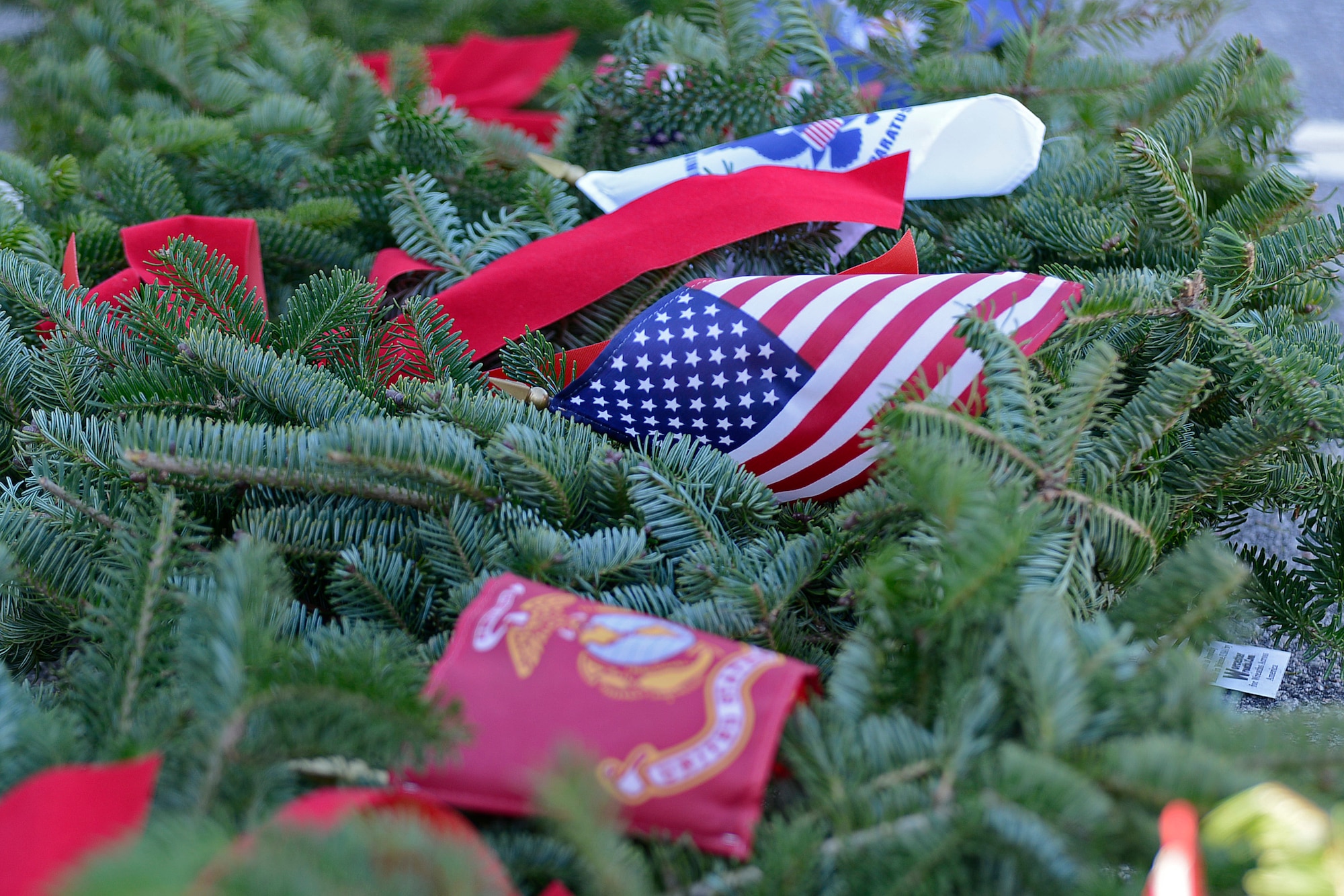 Wreaths lie on the ground waiting to be placed on stands at Sumter Cemetery in Sumter, S.C., Dec. 17, 2016. Wreaths Across America promotes laying wreaths on veterans’ graves to remember and honor them. (U.S. Air Force photo by Airman 1st Class BrieAnna Stillman) 