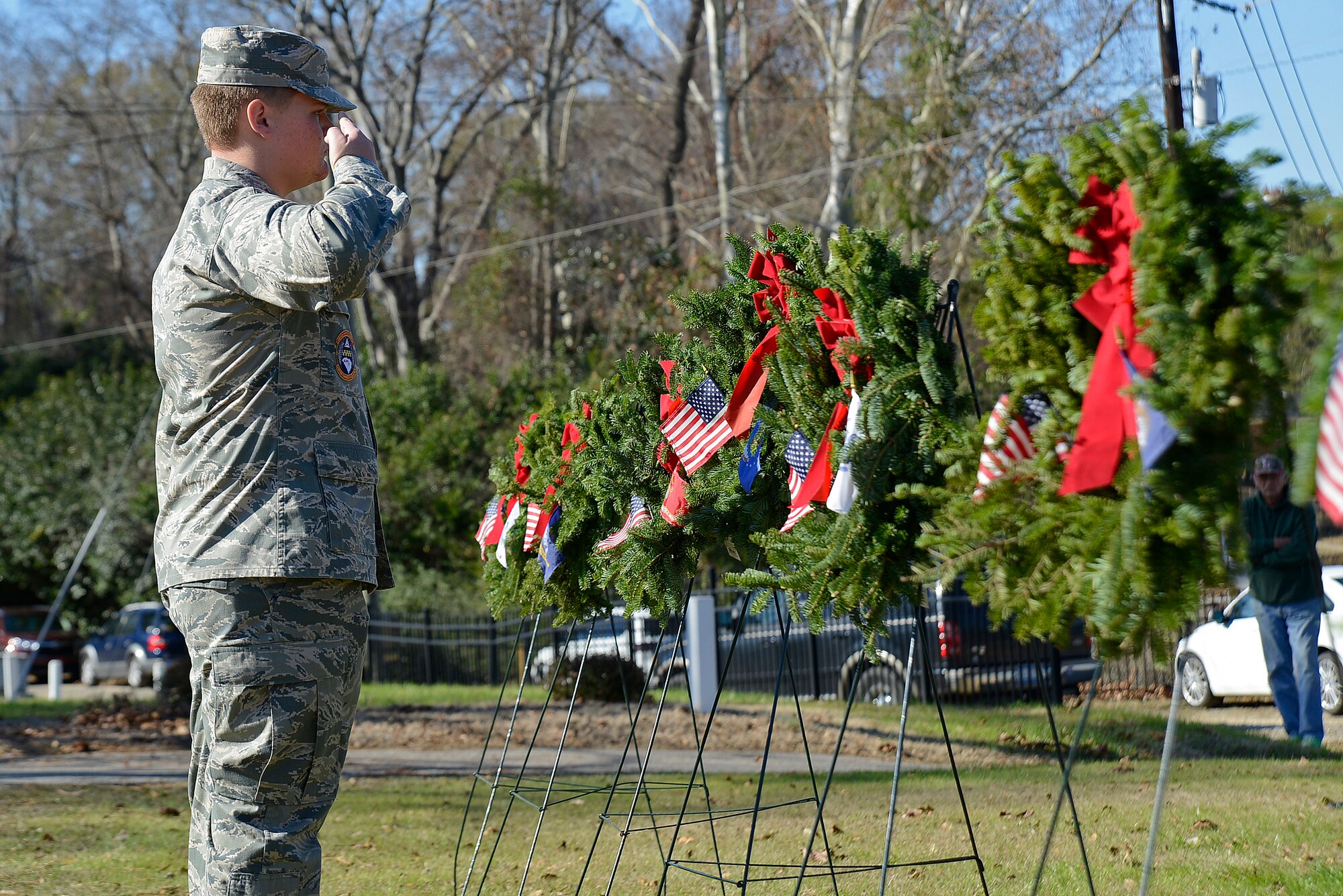 David Nabholz, Sumter Composite Squadron Civil Air Patrol cadet commander, salutes the final wreath set on a stand at Sumter Cemetery in Sumter, S.C., Dec. 17, 2016. Seven wreaths were placed on stands, one for each branch of the U.S. military, as well as one each for prisoners of war and the U.S. Merchant Marine Corps. (U.S. Air Force photo by Airman 1st Class BrieAnna Stillman)