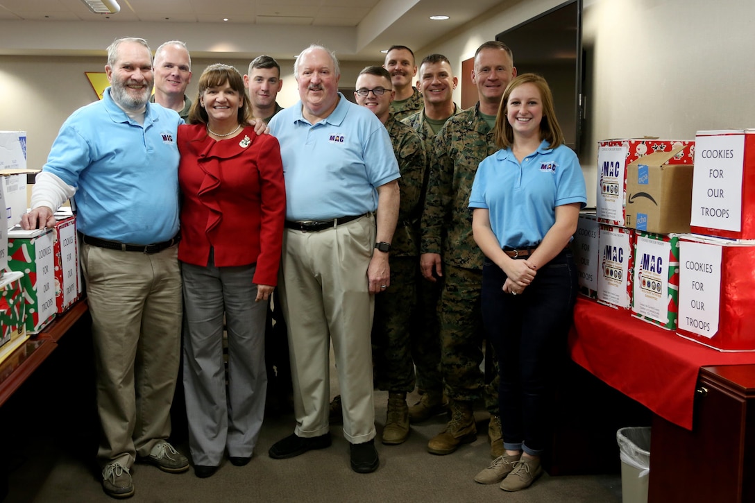Marine Corps Air Station Cherry Point Marines, a civilian and members of the Carteret County’s Chamber of Commerce’s Military Affairs Committee stand together beside donated boxes of cookies during an annual cookie drop aboard Marine Corps Air Station Cherry Point, N.C., Dec. 22, 2016. The Carteret County’s COC MAC donated 26 boxes of cookies to Marines and Sailors on duty aboard the air station. Elementary school students from Carteret County added homemade Christmas cards in the boxes to wish the service members a happy holiday season. (U.S. Marine Corps photo by Cpl. Jason Jimenez/ Released)