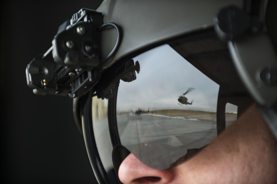 Master Sgt. Chris Baker, 37th Helicopter flight engineer, looks on as a 37th HS UH-1N Huey takes off the helipad at F.E. Warren Air Force Base, Wyo., Dec. 16, 2016. That days’ training consisted of search and rescue tactics and practicing emergency security response at a launch facility with the 790th Missile Security Forces Squadron. (U.S. Air Force photo by Staff Sgt. Christopher Ruano)