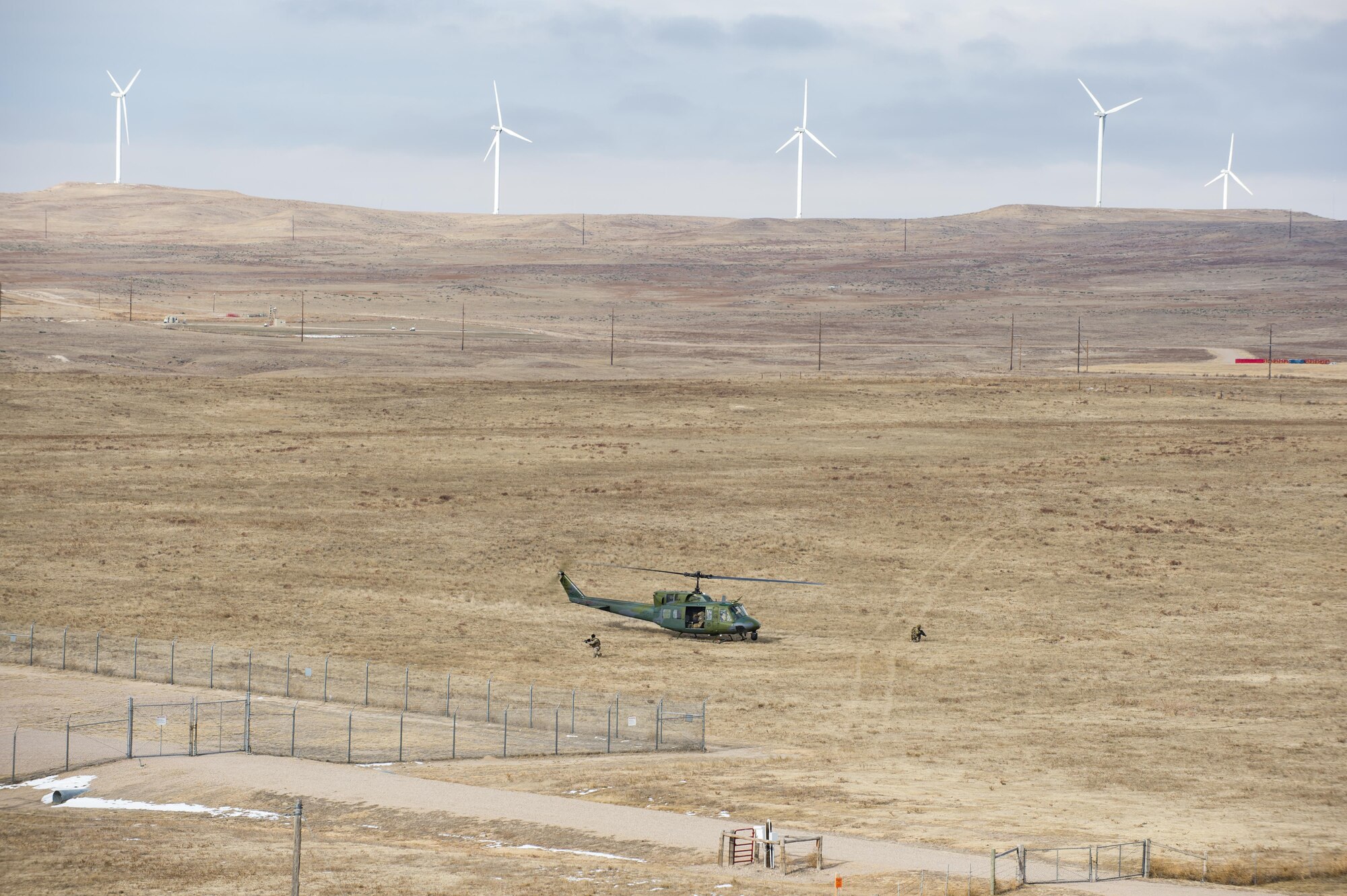 A 790th Missile Security Forces Squadron fireteam gets into position during emergency security response training with the 37th Helicopter Squadron at a launch facility in the F.E. Warren Air Force Base, Wyo., missile complex, Dec. 16, 2016. Helicopter aircrews and tactical response force security forces members are the only forces routinely taught to recapture a LF. (U.S. Air Force photo by Staff Sgt. Christopher Ruano)