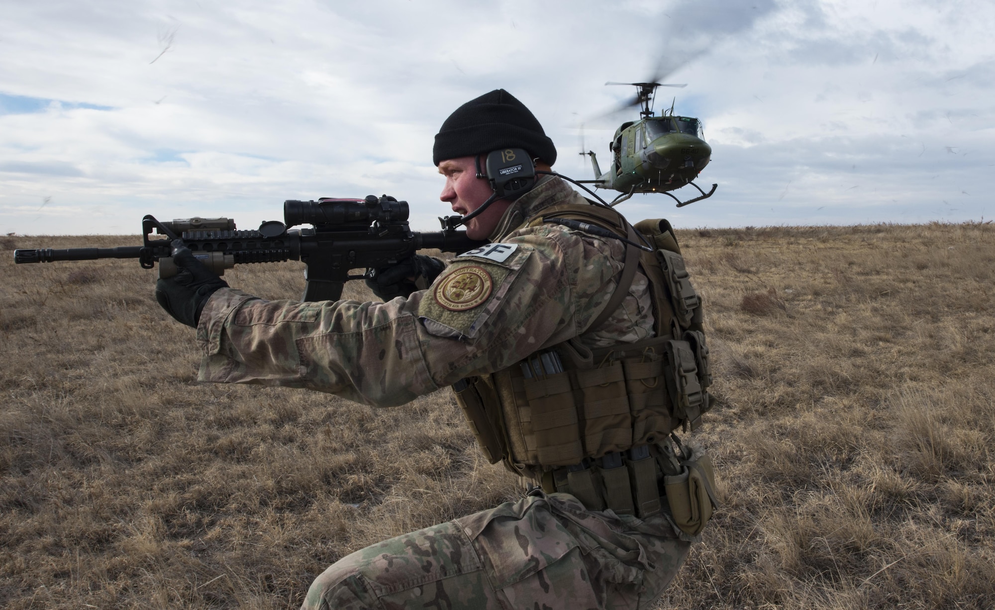 Senior Airman Joshua Hudson, 790th Missile Security Forces Squadron tactical response force assaulter, secures a landing site during emergency security response training with the 37th Helicopter Squadron at a launch facility in the F.E. Warren Air Force Base, Wyo., missile complex, Dec. 16, 2016. The 37th HS supports the mission of the 90th Missile Wing by providing aerial surveillance and emergency deployments of security response forces throughout the base and missile field. (U.S. Air Force photo by Staff Sgt. Christopher Ruano)