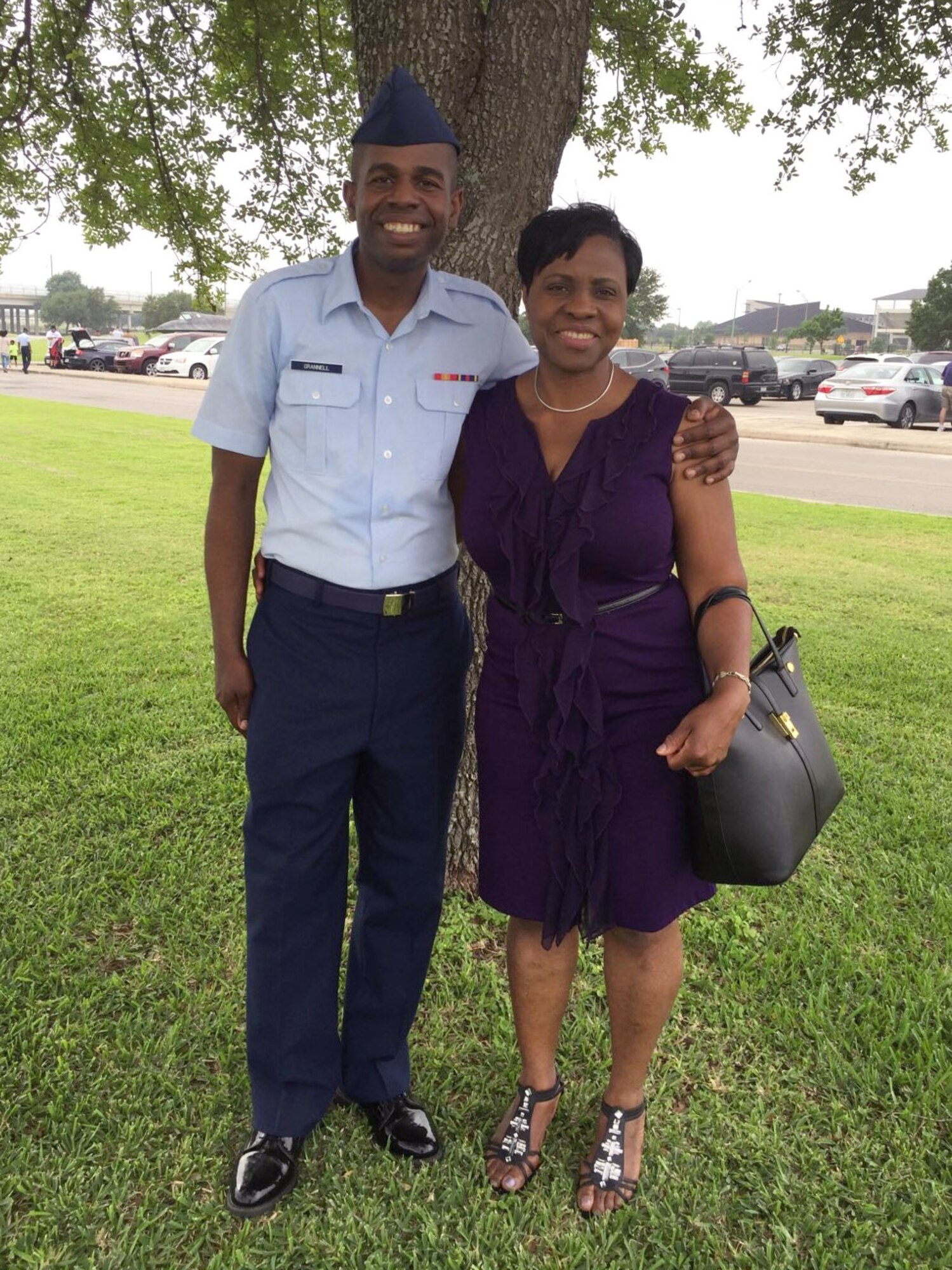 Airman Alfred Grannell, 460th Space Wing Comptroller Squadron budget analyst on Buckley Air Force Base, Colo., poses for a photo with his aunt, Winifred Brown of Waterbury, Connecticut, after graduating Basic Military Training April 29, 2016, on Joint Base San Antonio-Lackland, Texas. BMT is an eight-and-a-half-week program of physical and mental training required in order for an individual to become an Airman in the United States Air Force.
