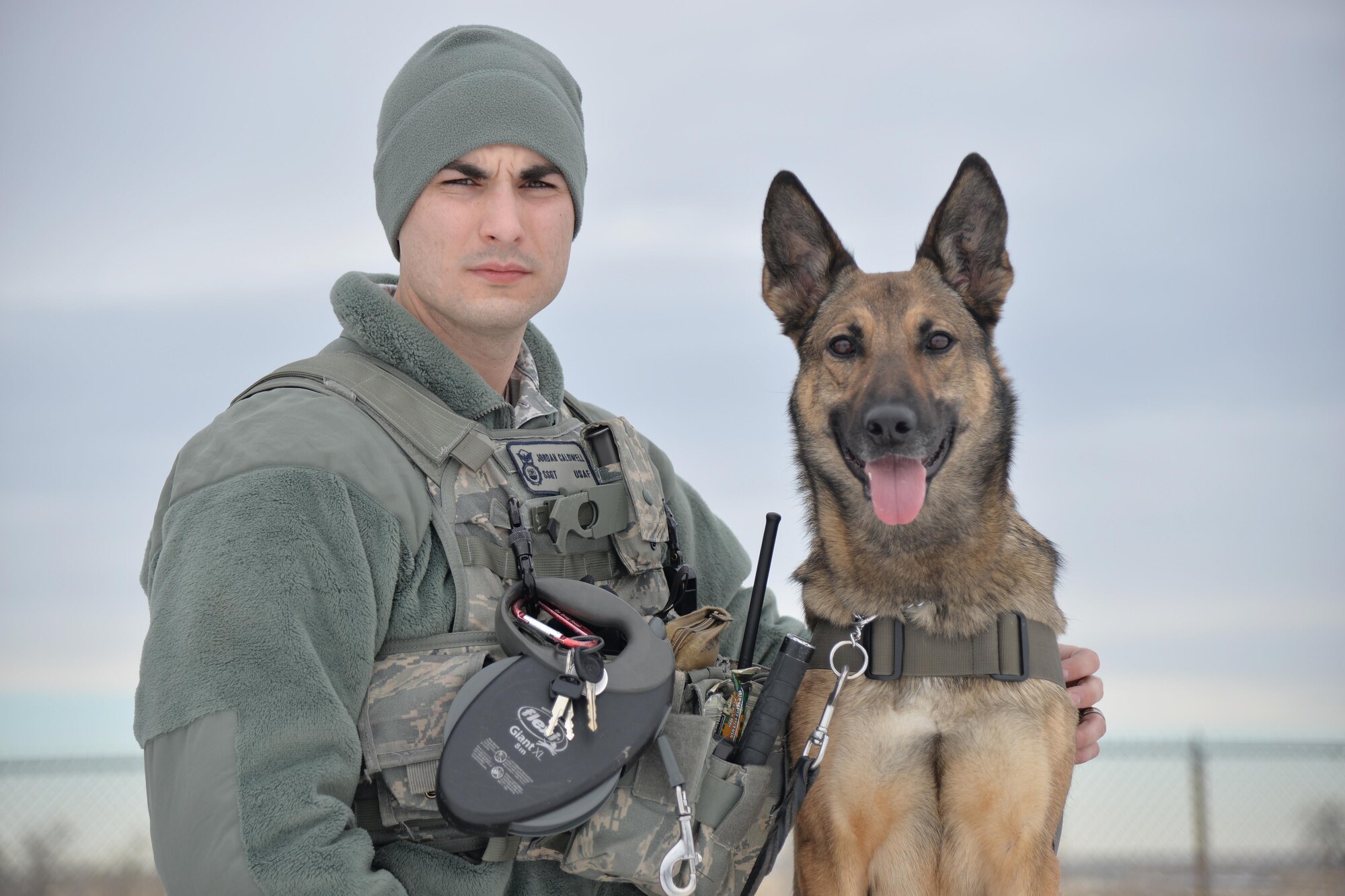 Staff Sgt. Jordan Caldwell, 341st Security Forces Squadron military working dog handler, and his K-9, Lady, pose for a photo Dec. 20, 2016, at Malmstrom Air Force Base, Mont. The bond between Caldwell and Lady took time and patience to build to what they have today. (U.S. Air Force photo/Airman 1st Class Daniel Brosam)