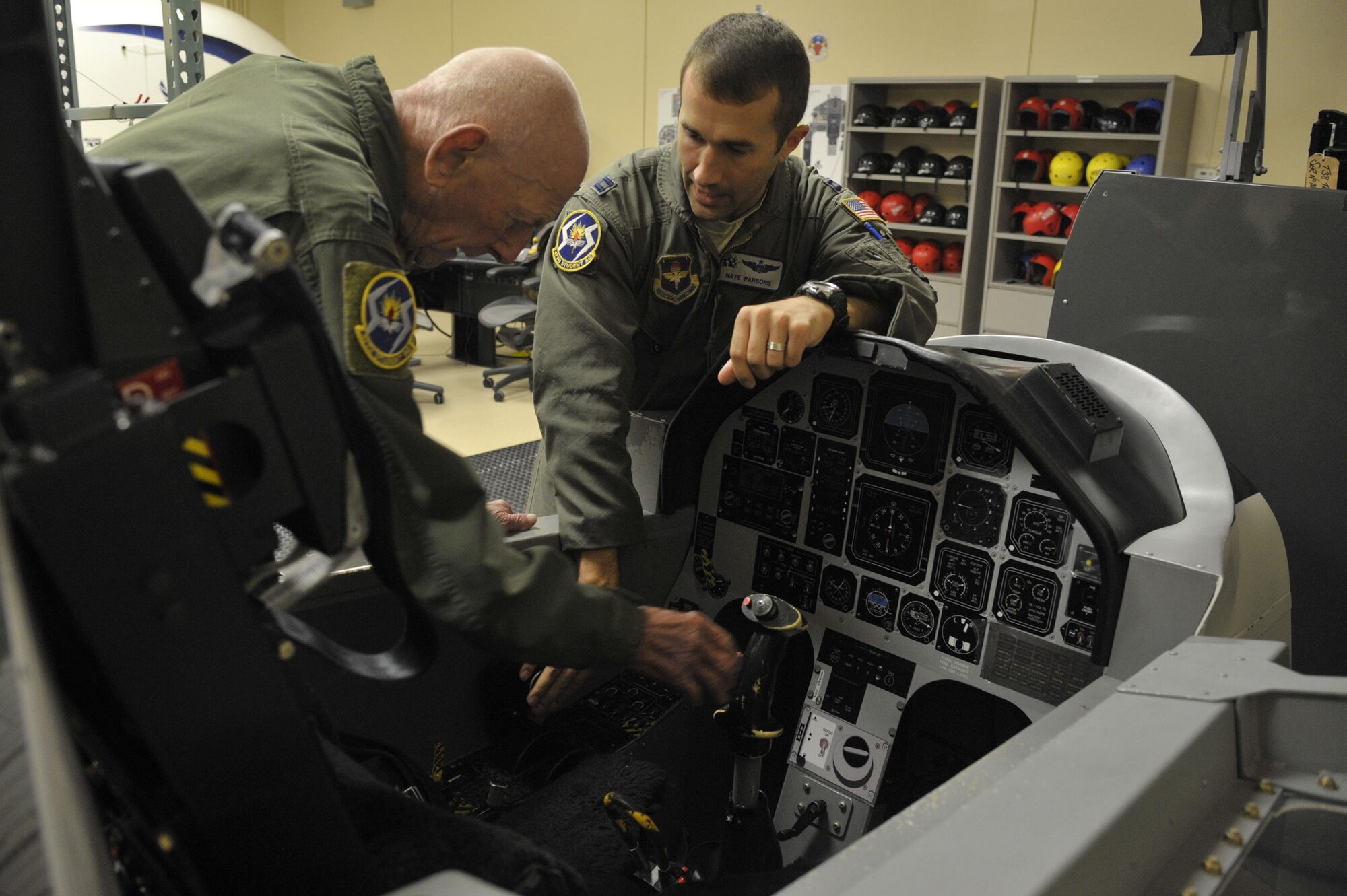 Capt. Steven Parsons, 47th Student Squadron T-6A Texan II instructor pilot, shows the T-6 trainer to retired Capt. Jerry Yellin, a former World War II U.S. Army Air Corps fighter pilot, during initial training for an orientation flight Dec. 16, 2016. After graduating from Luke Air Field as a fighter pilot in August of 1943, he spent the remainder of the war flying P-40, P- 47 Thunderbolt and P-51 Mustang combat missions in the Pacific with the 78th Fighter Squadron, known as the "Bushmasters." (U.S. Air Force photo/Tech. Sgt. Mike Meares)