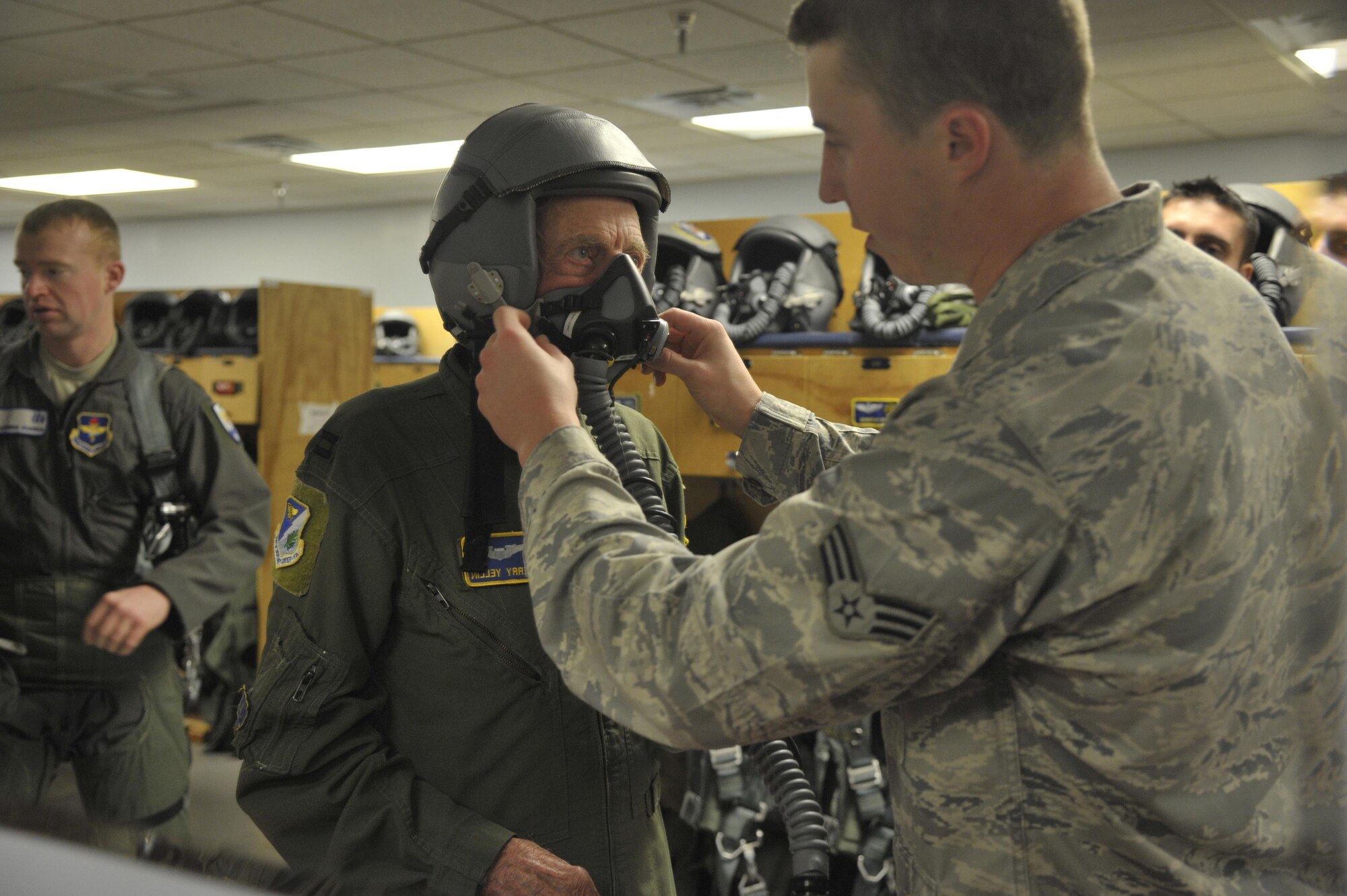 Capt. Jerry Yellin, a former U.S. Army Air Corps fighter pilot, is fitted for a helmet and face mask by Senior Airman Todd Brackenbury, 47th Operations Support Squadron, in preparation for an orientation flight at Laughlin Air Force Base, Texas, Dec. 16, 2016. Yellin, 92, enlisted two months after the bombing of Hickam Air Field and Pearl Harbor, Hawaii, on his 18th birthday. After graduating from Luke Air Field as a fighter pilot in August of 1943, he spent the remainder of the war flying P-40, P- 47 Thunderbolt and P-51 Mustang combat missions in the Pacific with the 78th Fighter Squadron, known as the "Bushmasters," signified by the open-mouth snake’s head worn on their patches. (U.S. Air Force photo/Tech. Sgt. Mike Meares)