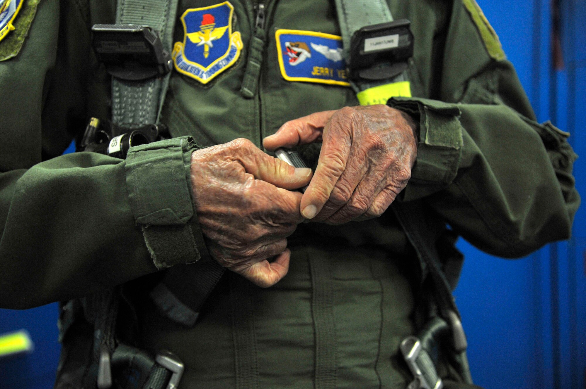 Capt. Jerry Yellin, a former U.S. Army Air Corps fighter pilot, clips his harness in preparation for an orientation flight in a T-6A Texan II at Laughlin Air Force Base, Texas, Dec. 16, 2016. Yellin, 92, enlisted two months after the bombing of Hickam Air Field and Pearl Harbor, Hawaii, on his 18th birthday. After graduating from Luke Air Field as a fighter pilot in August of 1943, he spent the remainder of the war flying P-40, P- 47 Thunderbolt and P-51 Mustang combat missions in the Pacific with the 78th Fighter Squadron, known as the "Bushmasters," signified by the open-mouth snake’s head worn on their patches. (U.S. Air Force photo/Tech. Sgt. Mike Meares)