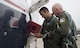 Capt. Steven Parsons, 47th Student Squadron assistant director of operations, and Jerry Yellin, author and retired U.S. Army Air Corps Captain, go over the aircraft forms before their flight in a T-6A Texan II on Laughlin Air Force Base, Texas, Dec. 15, 2016. The aircraft forms include all maintenance performed on the aircraft. (U.S. Air Force photo/Senior Airman Ariel D. Partlow)