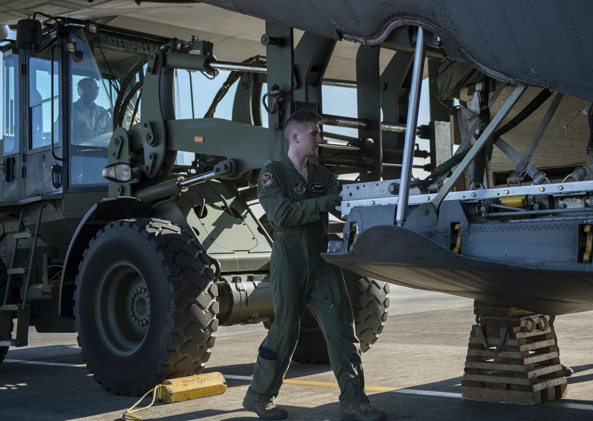Airman 1st Class Christian Williams, 36th Airlift Squadron C-130 loadmaster, helps load cargo onto a C-130 Hercules on Dec. 15, 2016, at Yokota Air Base, Japan. Williams ensures the C-130 is ready for Yokota’s last flight of the year. (U.S. Air Force photo by Airman 1st Class Juan Torres)